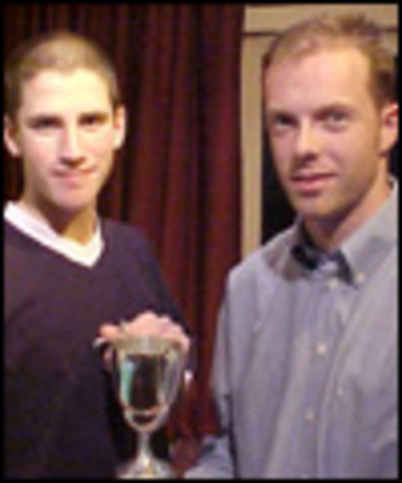 Accrington Under 15s captain Graeme Sneddon receives the Under 15s league trophy from Lee Boyer