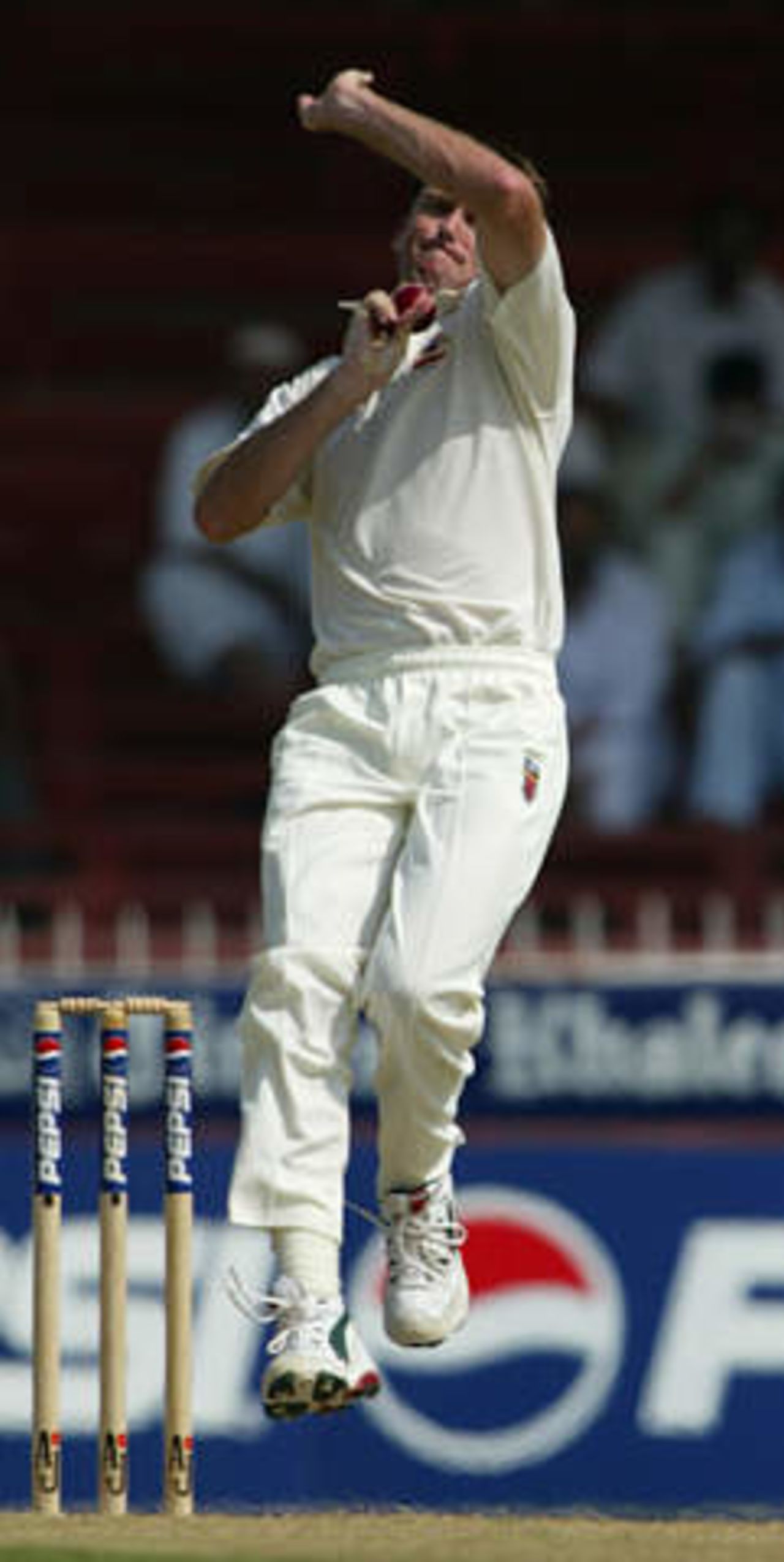 Australian bowler Glenn McGrath delivers to a Pakistani batsman at Sharjah's stadium October 11, 2002 at the start of their second cricket test. The second and third tests are being held in the neutral venue of Sharjah after Australia balked at playing in Pakistan due to security concerns.