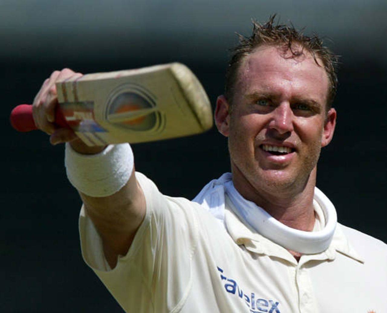 Australia's Matthew Hayden tips his bat to fans while walking off for lunch after scoring a century against Pakistan at Sharjah's stadium October 12, 2002 on the second day of their second cricket test match. The second and third tests are being held in the neutral venue of Sharjah after Australia balked at playing in Pakistan due to security concerns.