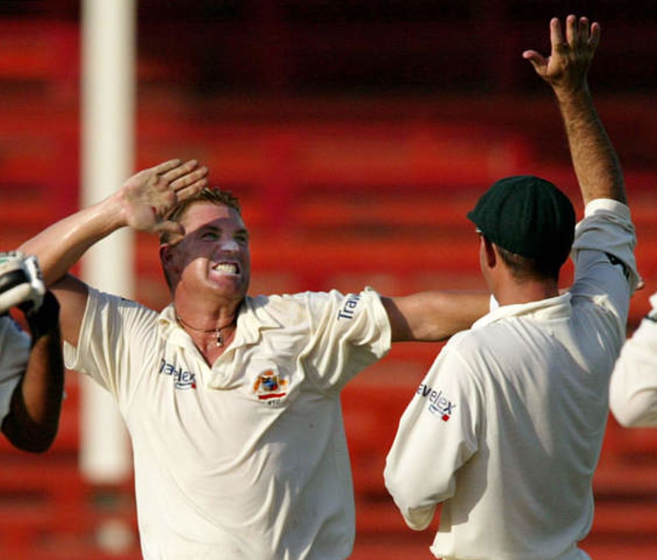 Australian spin bowler Shane Warne celebrates winning the second cricket test match against Pakistan with team mate Ricky Ponting (R) at Sharjah's stadium October 12, 2002. Pakistan crumbled to defeat in less than two days of the second test against Australia on Saturday, adding just 53 to their first innings 59 and losing by an innings and 198 runs. Pakistan's match total of 112 was the fourth worst in test history.