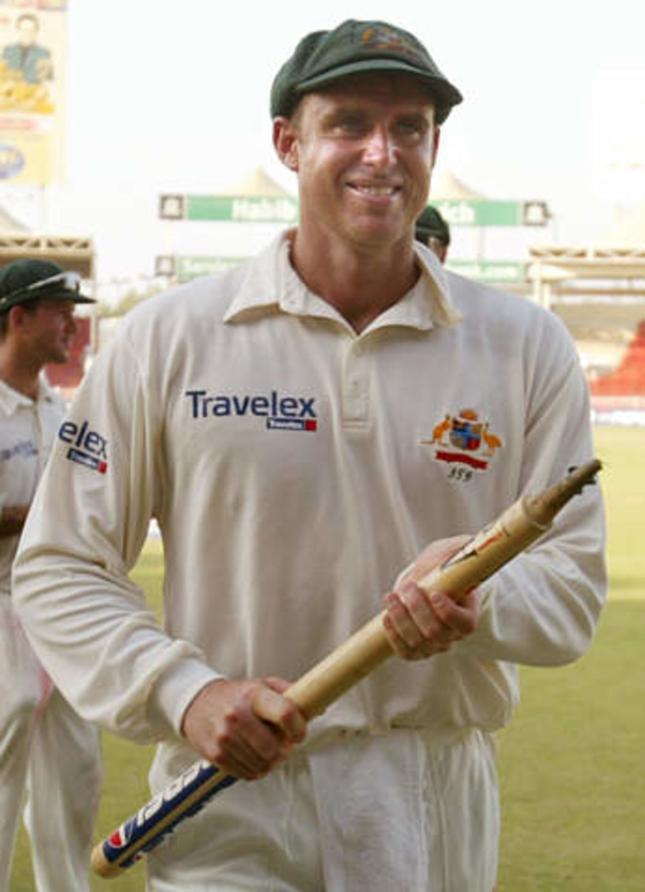 Australian high scoring batsman Matthew Hayden carries one of the stumps after defeating Pakistan in their second cricket test match in Sharjah's stadium October 12, 2002. Pakistan crumbled to defeat in less than two days of the second test against Australia on Saturday, adding just 53 to their first innings 59 and losing by an innings and 198 runs. Pakistan's match total of 112 was the fourth worst in test history.