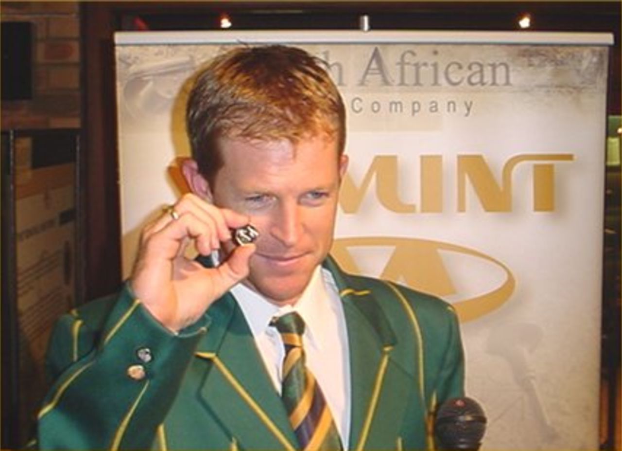 Jonty Rhodes and the first commemorative South Africa coin moments after minting it.