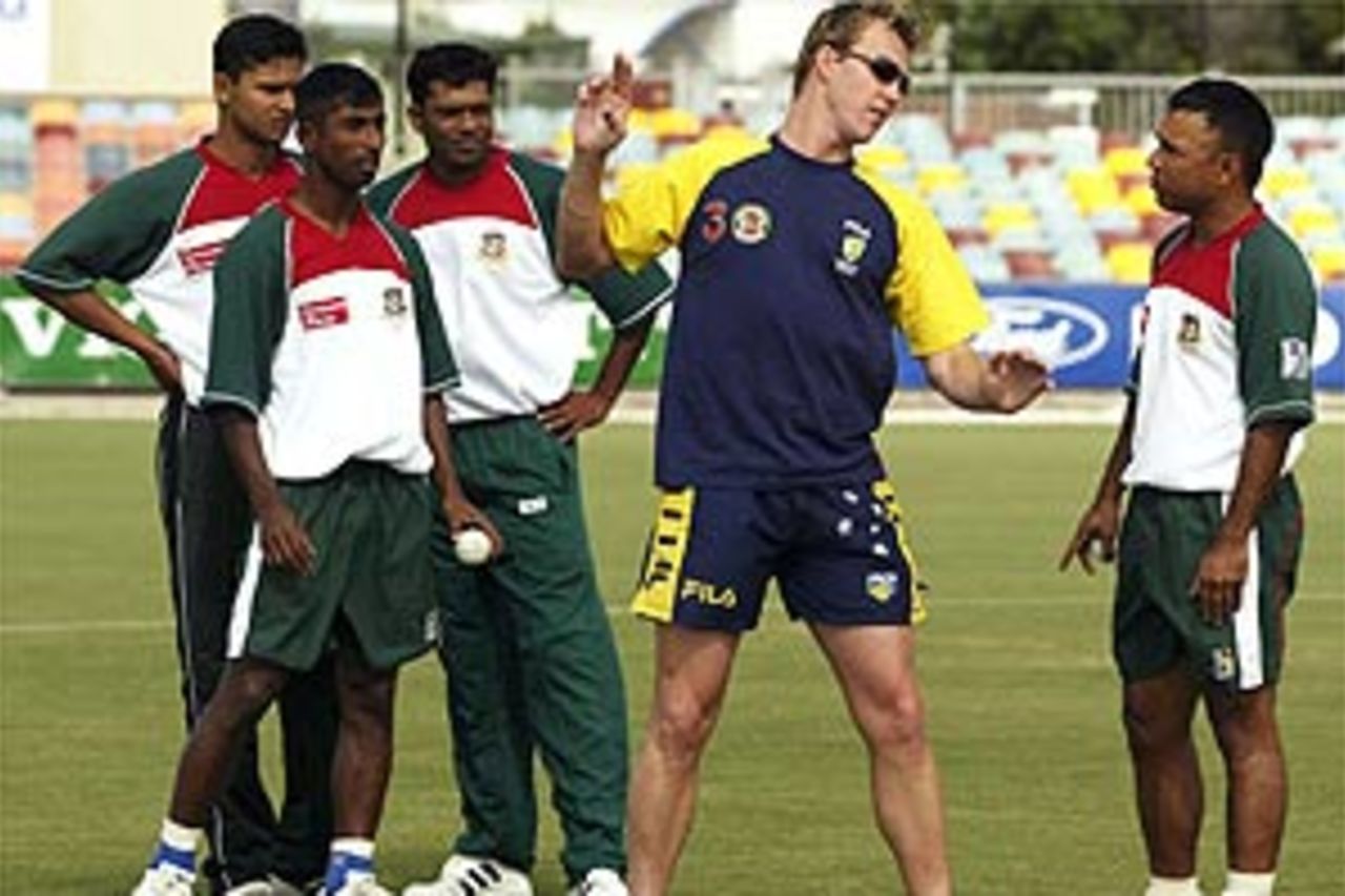 Brett Lee of Australia speaks to the Bangladesh fast bowlers during training at Bundaberg Rum Stadium on August 1, 2003 in Cairns, Australia
