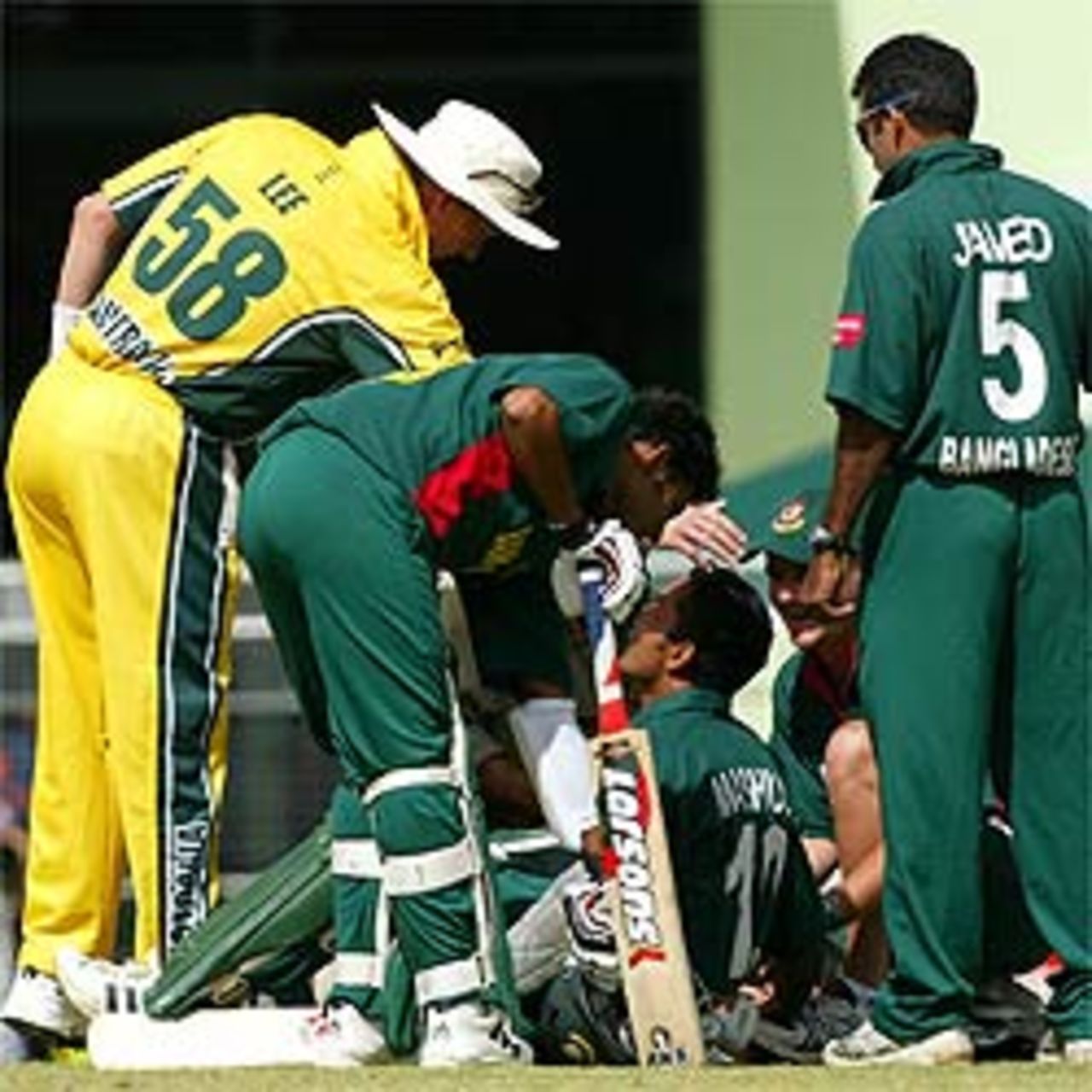 Brett Lee of Australia checks on the health of Khaled Mashud of Bangladesh during the 1st One Day International between Australia and Bangladesh played at Bundaberg Rum Stadium on August 2, 2003, Cairns, Australia.