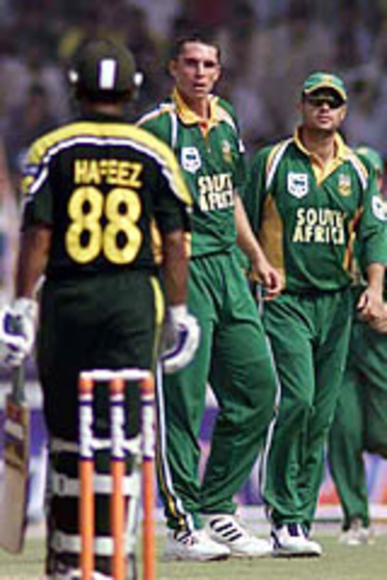 Andre Nel and Mohammad Hafeez exchange looks, Pakistan v South Africa, 3rd ODI, Faisalabad, October 7, 2003.