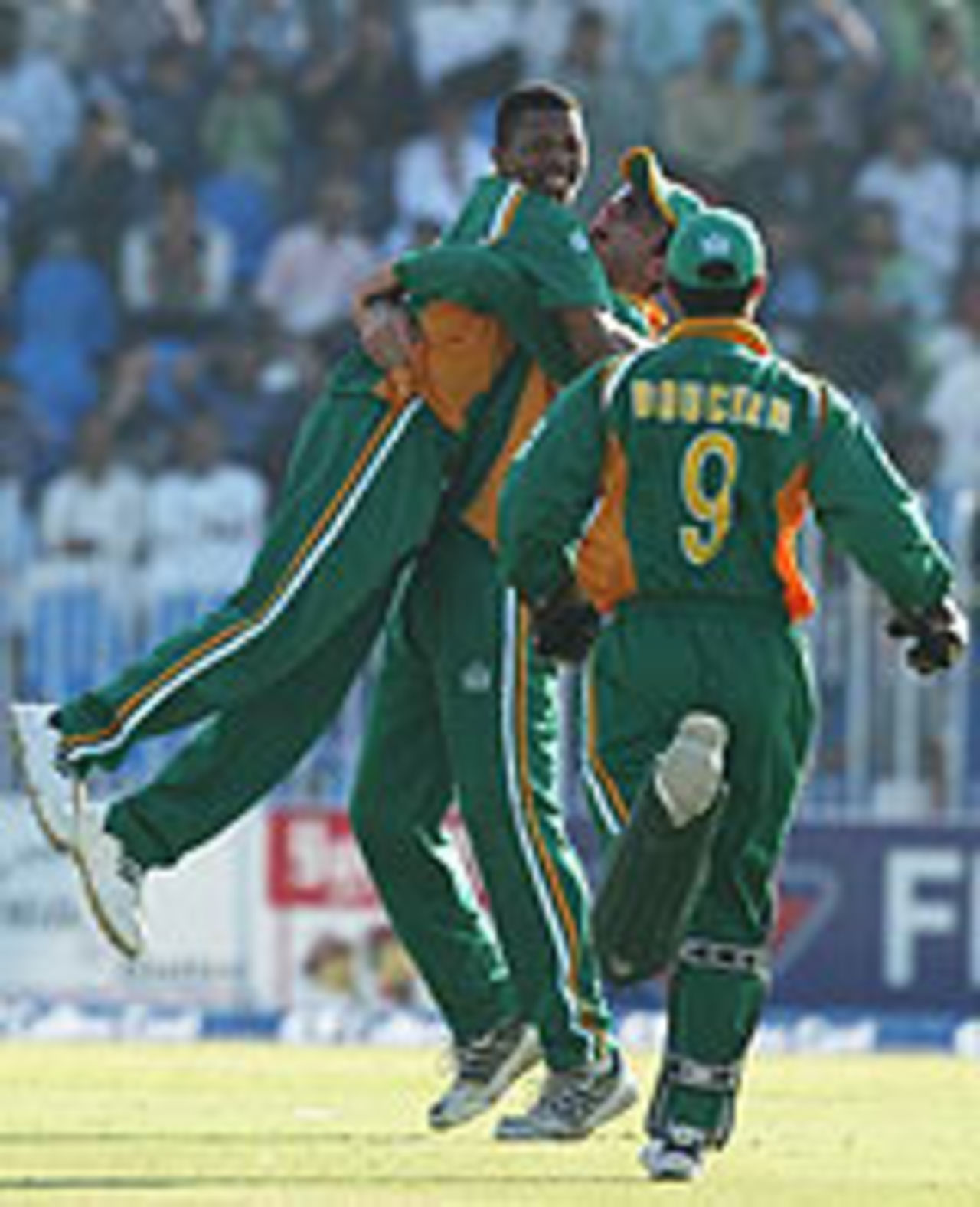 Shaun Pollock and Andre Nel celebrate as South Africa close in on victory in the 4th ODI, Pakistan v South Africa, 4th ODI, October 10, 2003