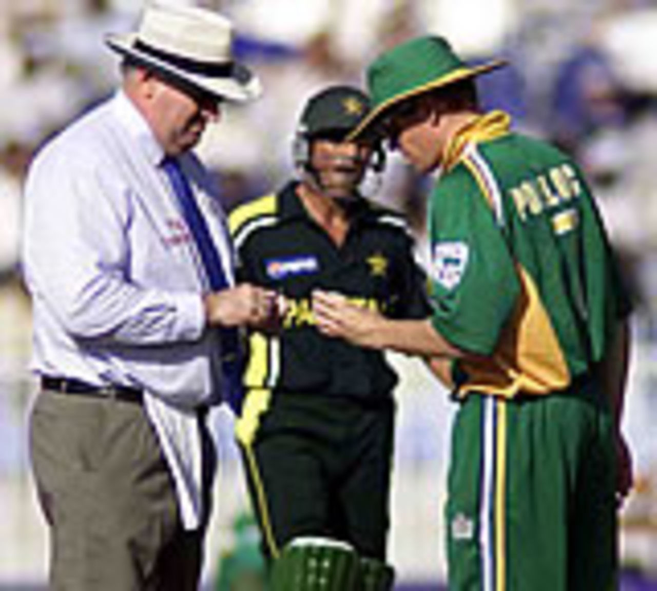 Umpire Darrell Hair performs some surgery on the ball for Shaun Pollock, Pakistan v South Africa, 4th ODI, Rawalpindi, October 10, 2003.