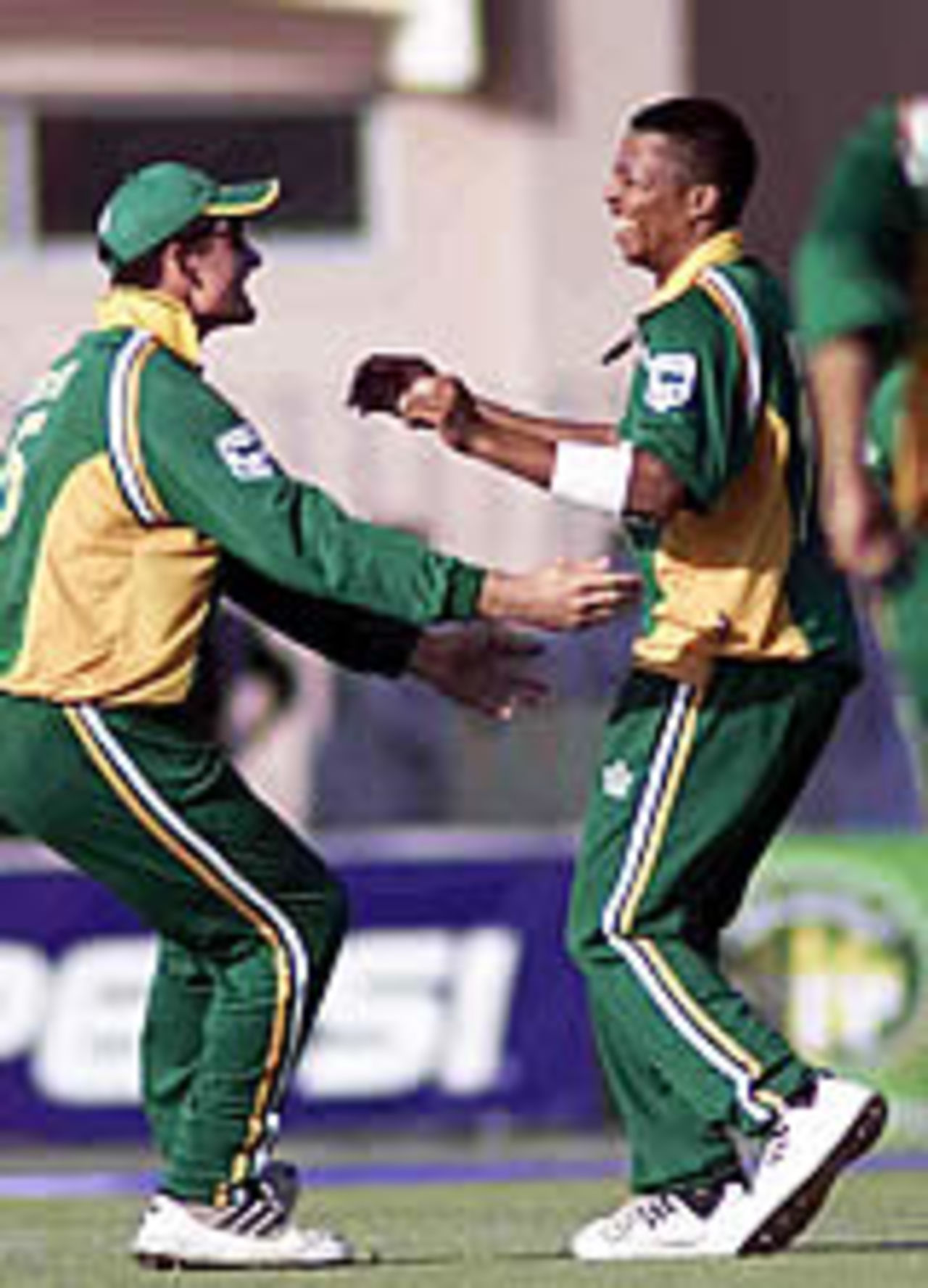 Makhaya Ntini and Graeme Smith share the joy after Shoaib Malik's dismissal, Pakistan v South Africa, 4th ODI, Rawalpindi, October 10, 2003.