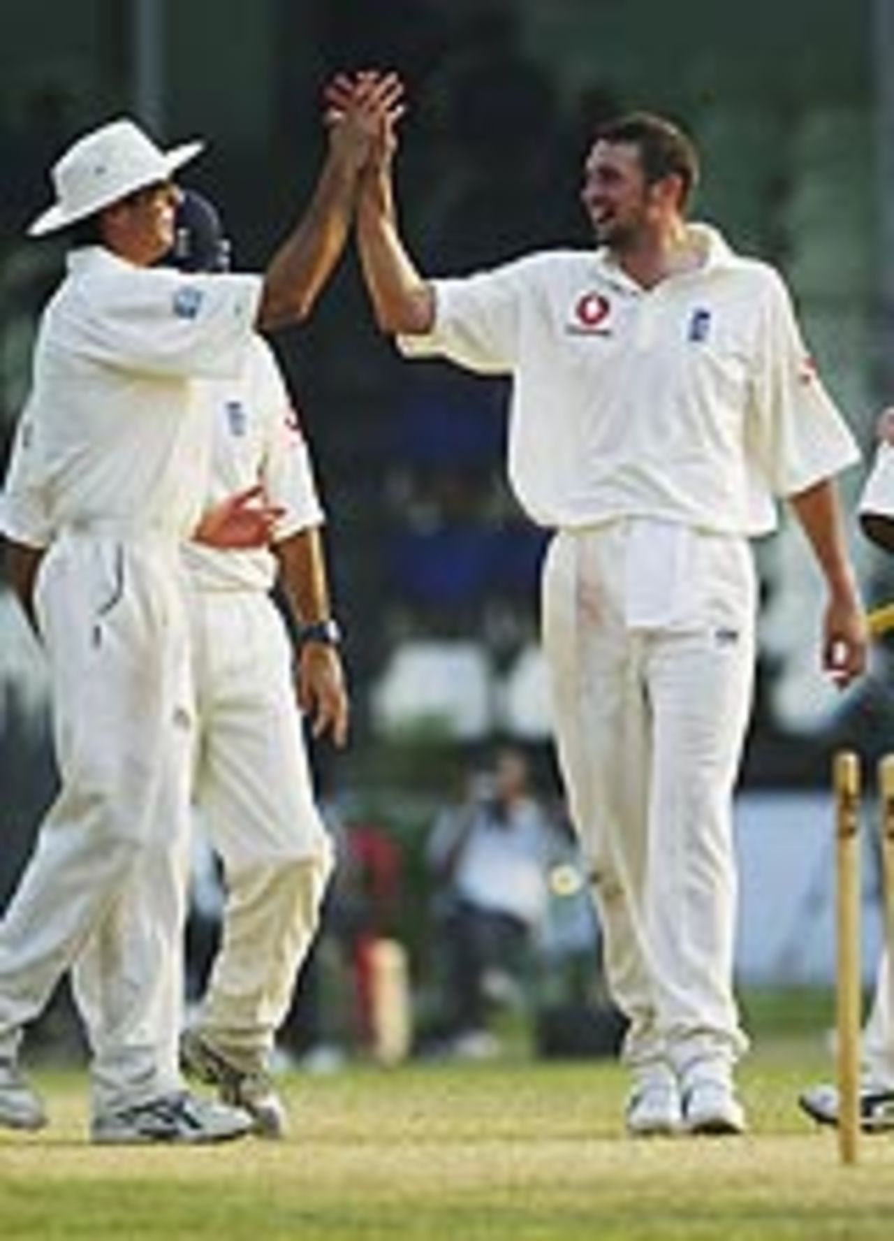 Steve Harmison receives the congratulations of his captain after another wicket