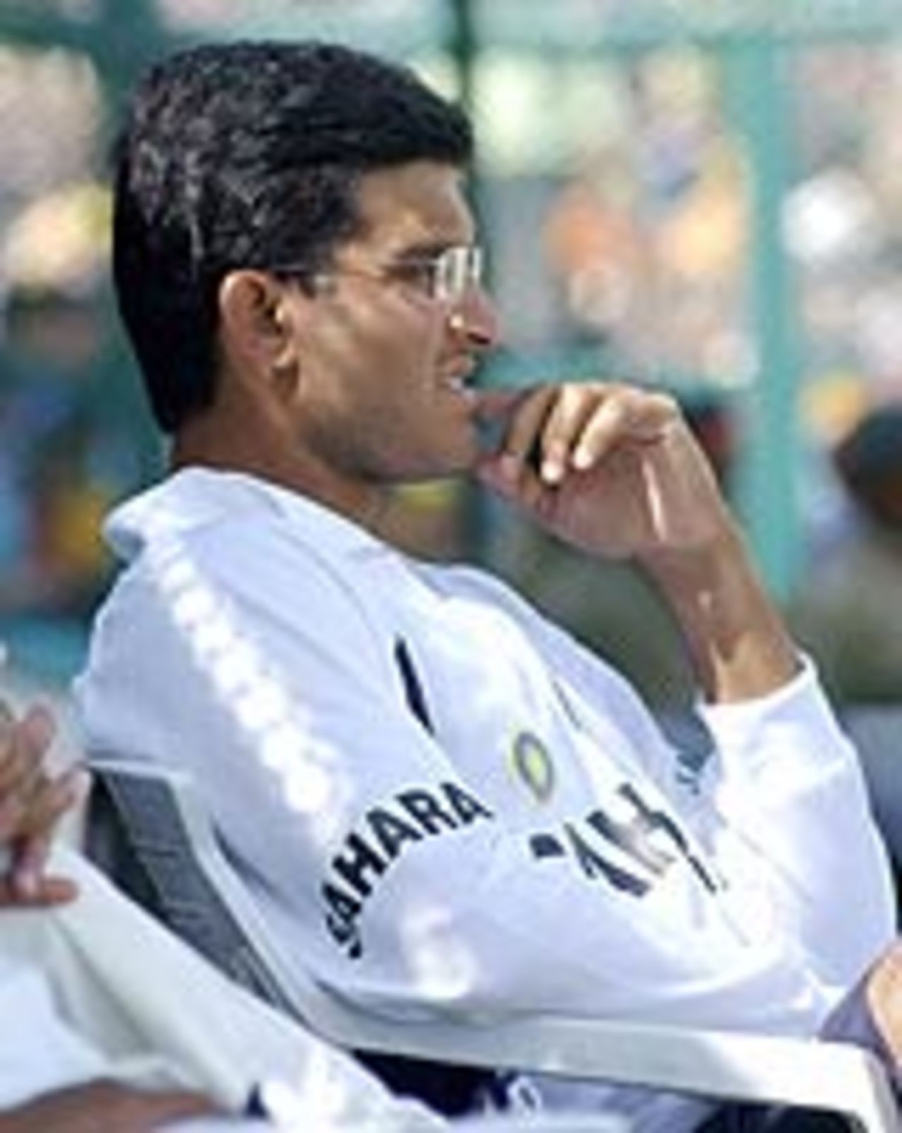 The injured Sourav Ganguly looks on as India struggle on the first day of the second Test against New Zealand, October 16, 2003