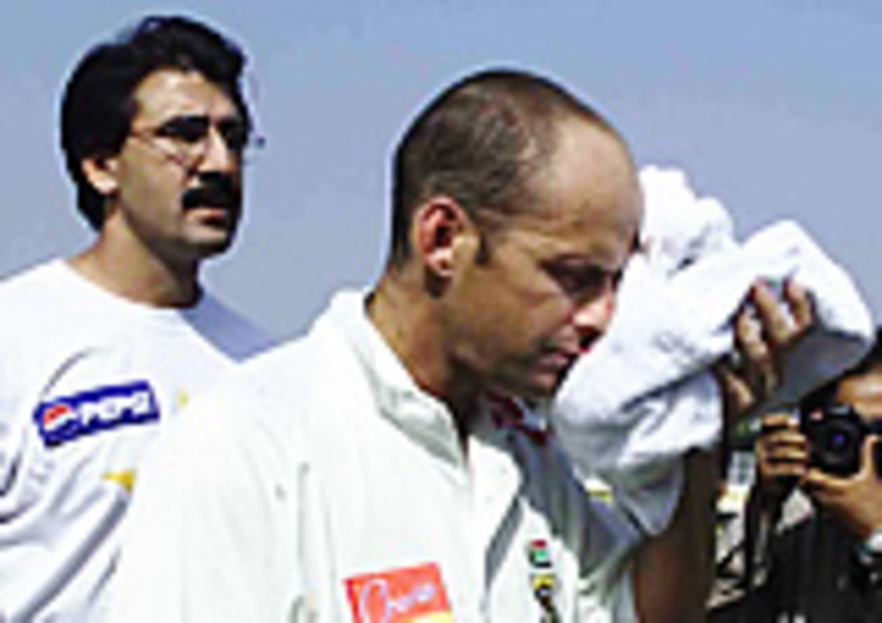 Gary Kirsten accompanied by the Pakistan physio walks back after being struck on the face by a Shoaib Akhtar bouncer, Pakistan v South Africa, Day 1, 1st Test, Lahore, October 17, 2003.