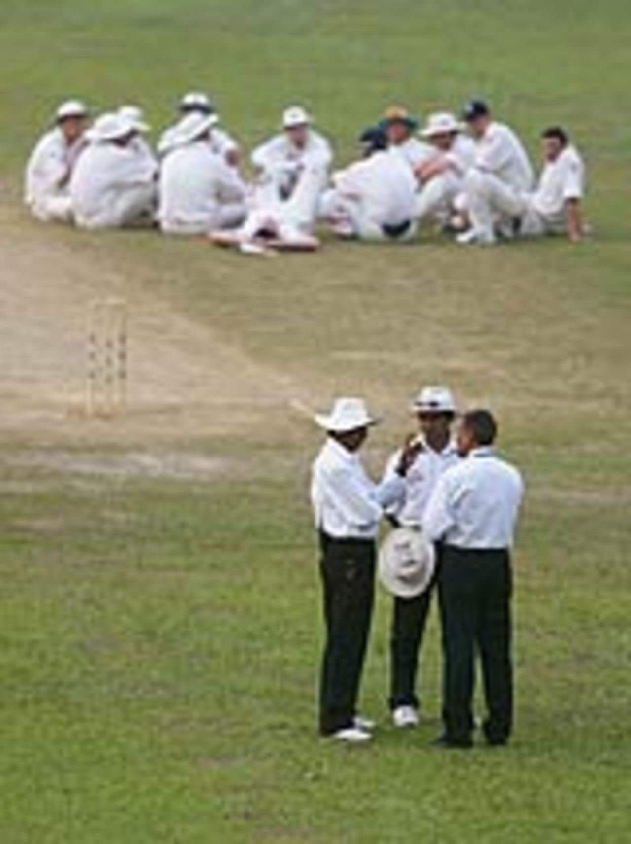England players sit on the outfield and wait following a power cut, Bangladesh v England, 1st Test, Dhaka, October 23, 2003