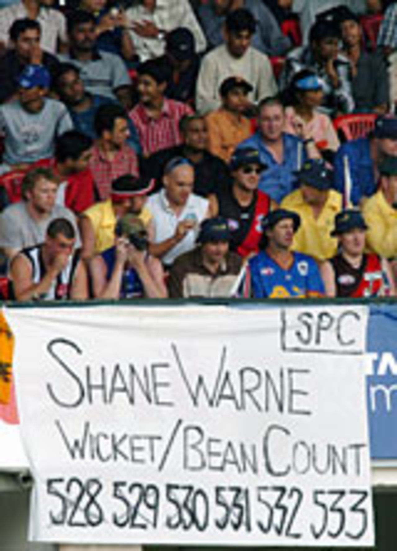 Spectators with Shane Warne banner