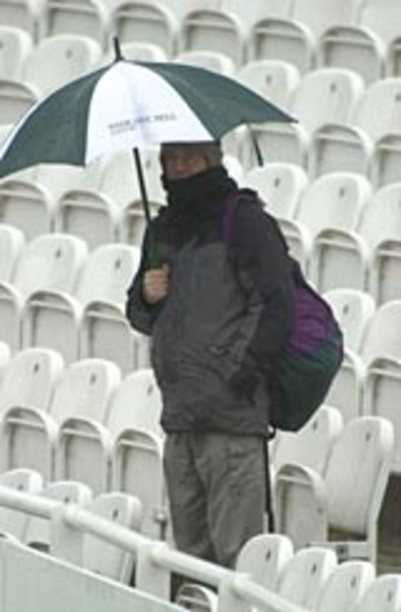 A lone spectator wraps up against the cold and the wet, England v Pakistan, Lord's, May 2001