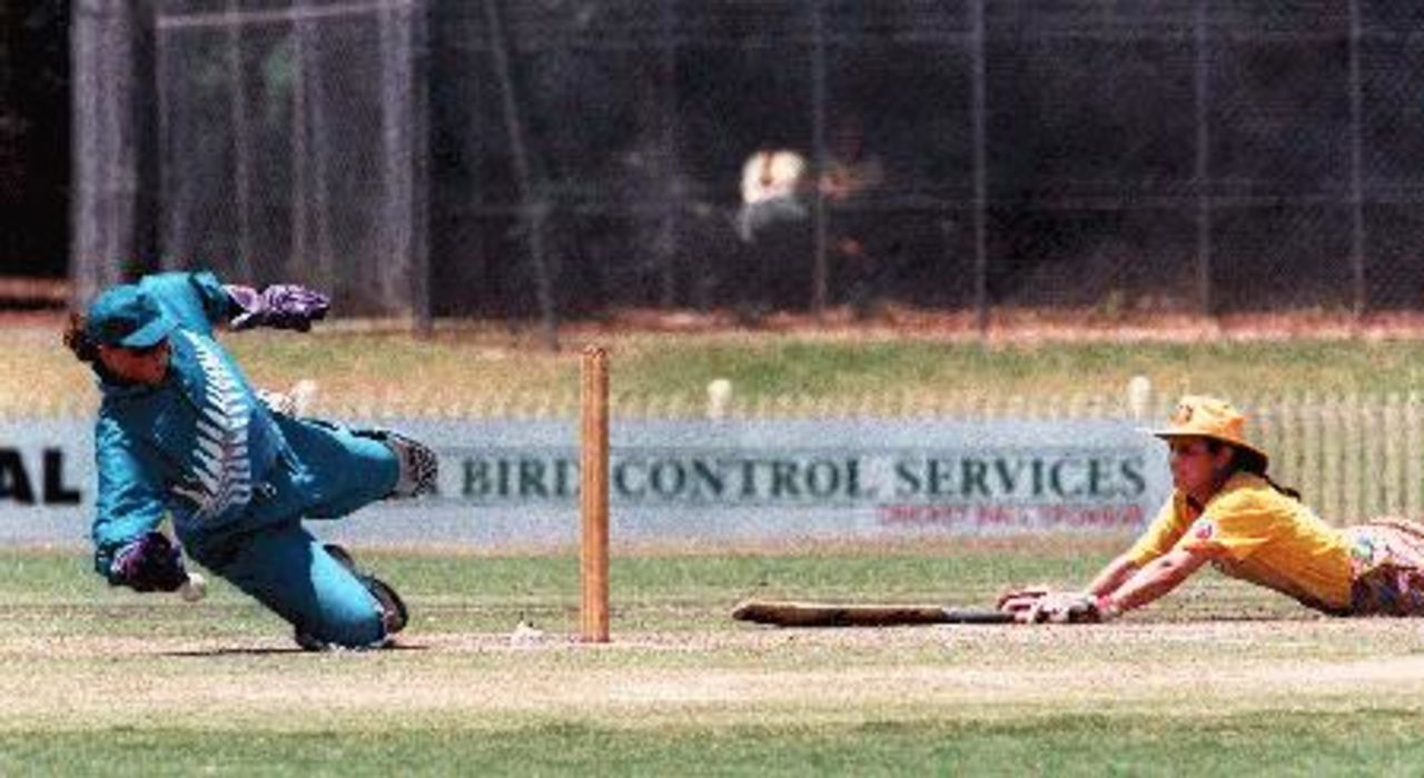 NZ keeper Rebecca Rolls dives for the ball as Olivia Magno slides safely home.  Aust v NZ Womens 2nd ODI at Bankstown Oval, 7 Nov 1997.