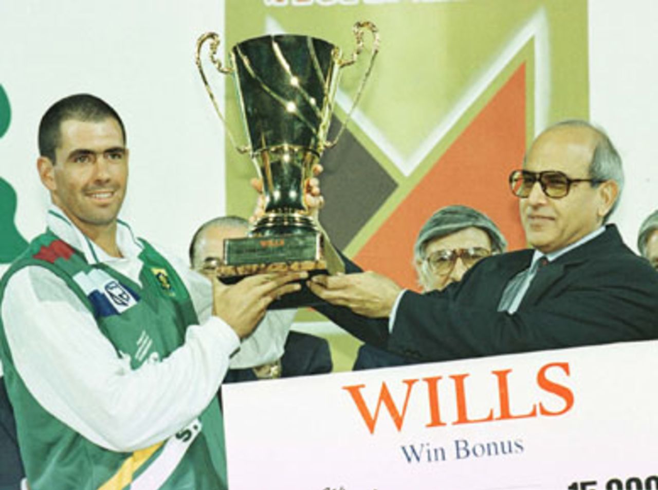 South African captain Hansie Cronje accepts the Wills Quadrangular Tournament Trophy from The President of Pakistan, Farooq Leghari. 8th November 1997.
