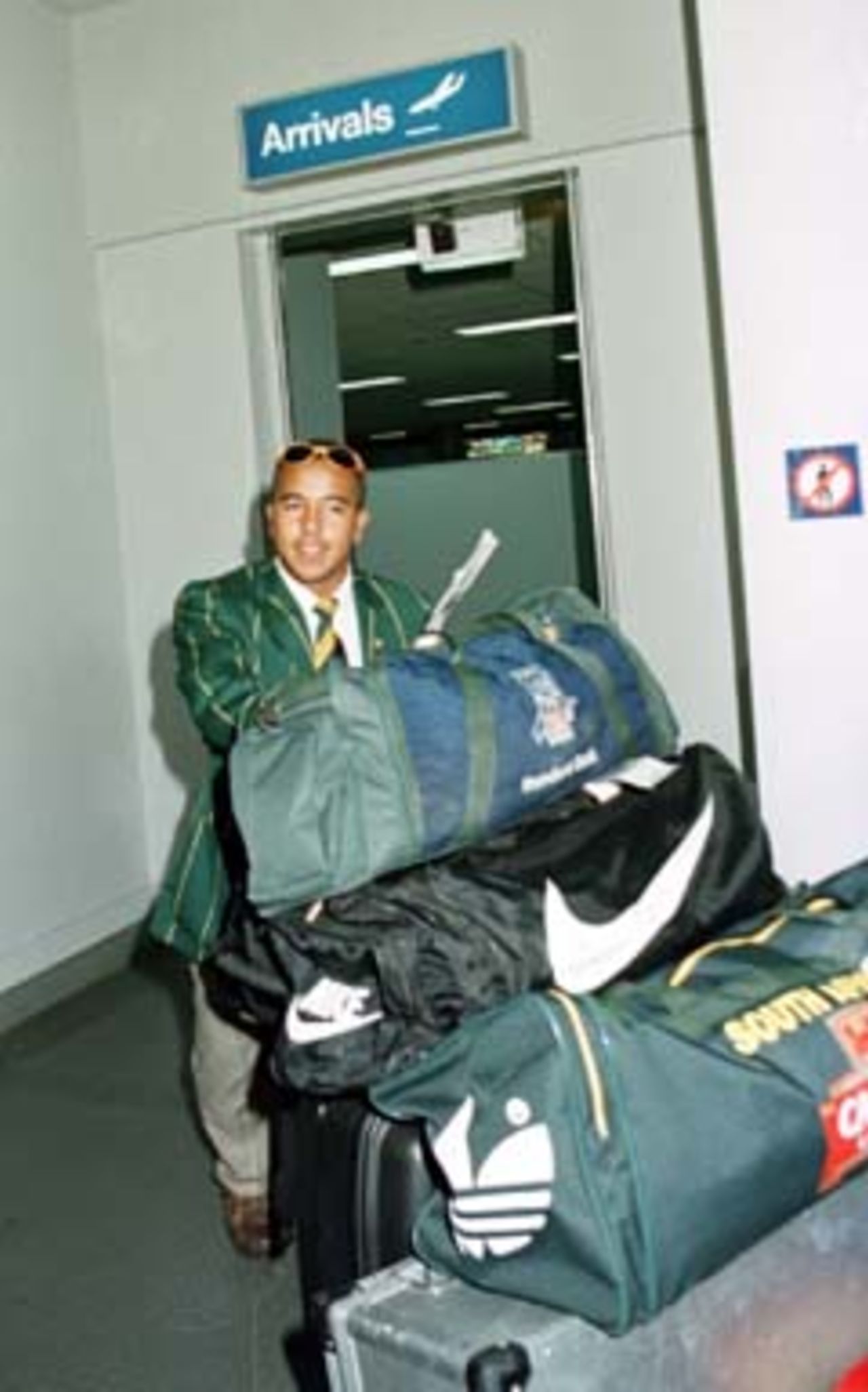 Paul Adams is dwarfed by his baggage on arrival at Perth International Airport. Friday November 21st 1997.