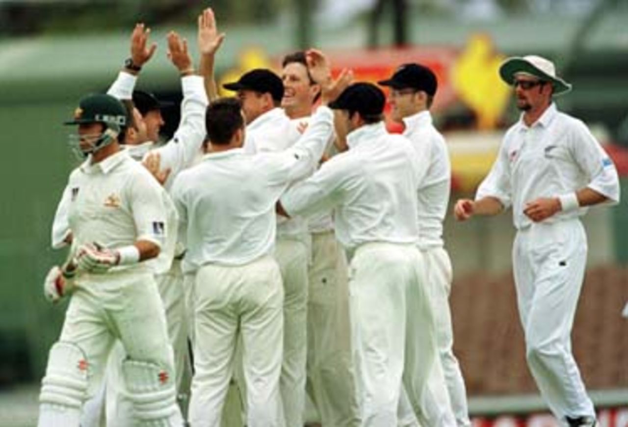 Greg Blewett walks off as the Kiwis celebrate with wicket taker O'Connor in the centre . Australia v New Zealand 2nd Test, Day Two, at the WACA, Perth, Thursday November 21st 1997