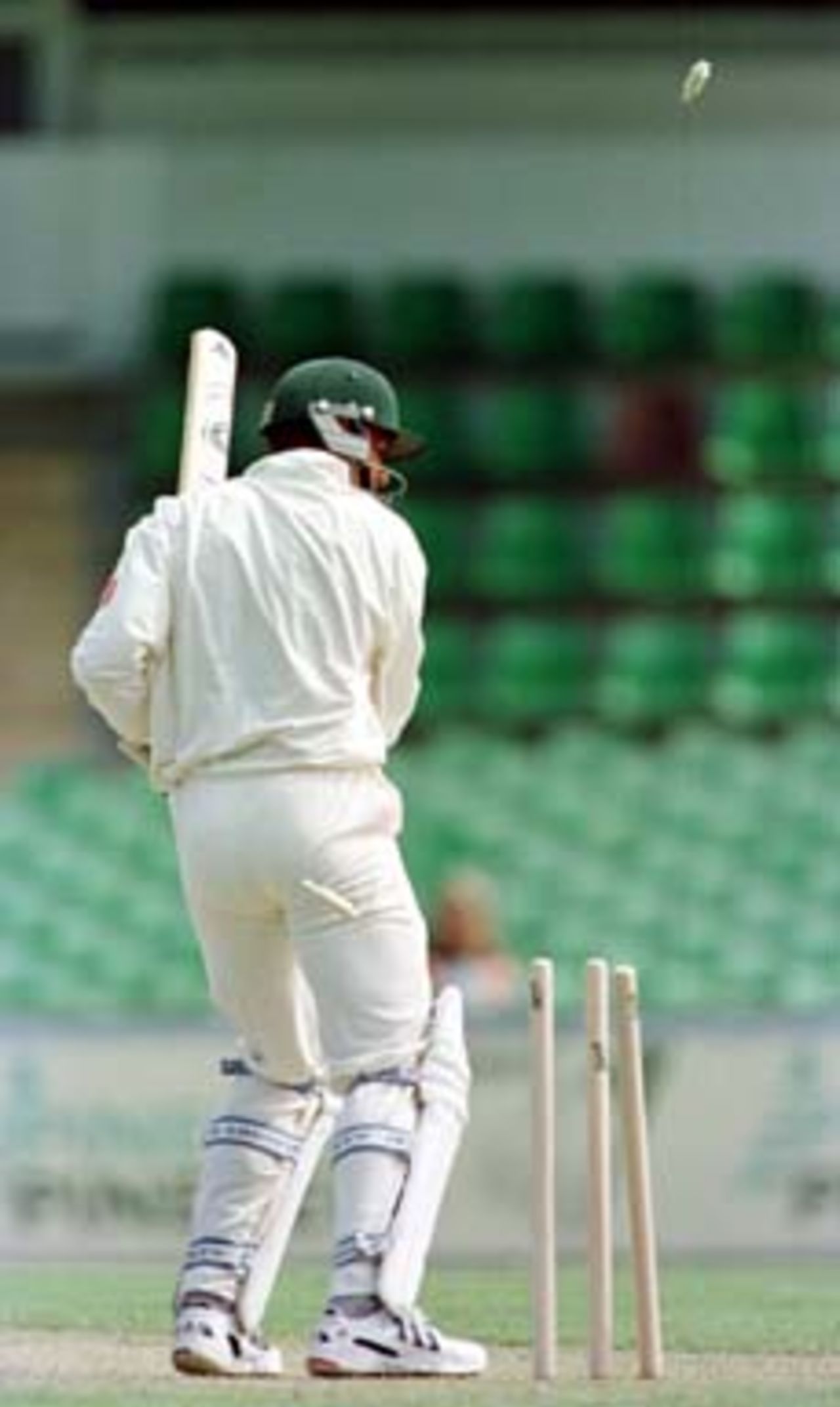 The bails fly high and low as Cronje chops the ball onto his wicket..South Africa v Western Australia, WACA Perth, Day 1, Thursday November 27th 1997.