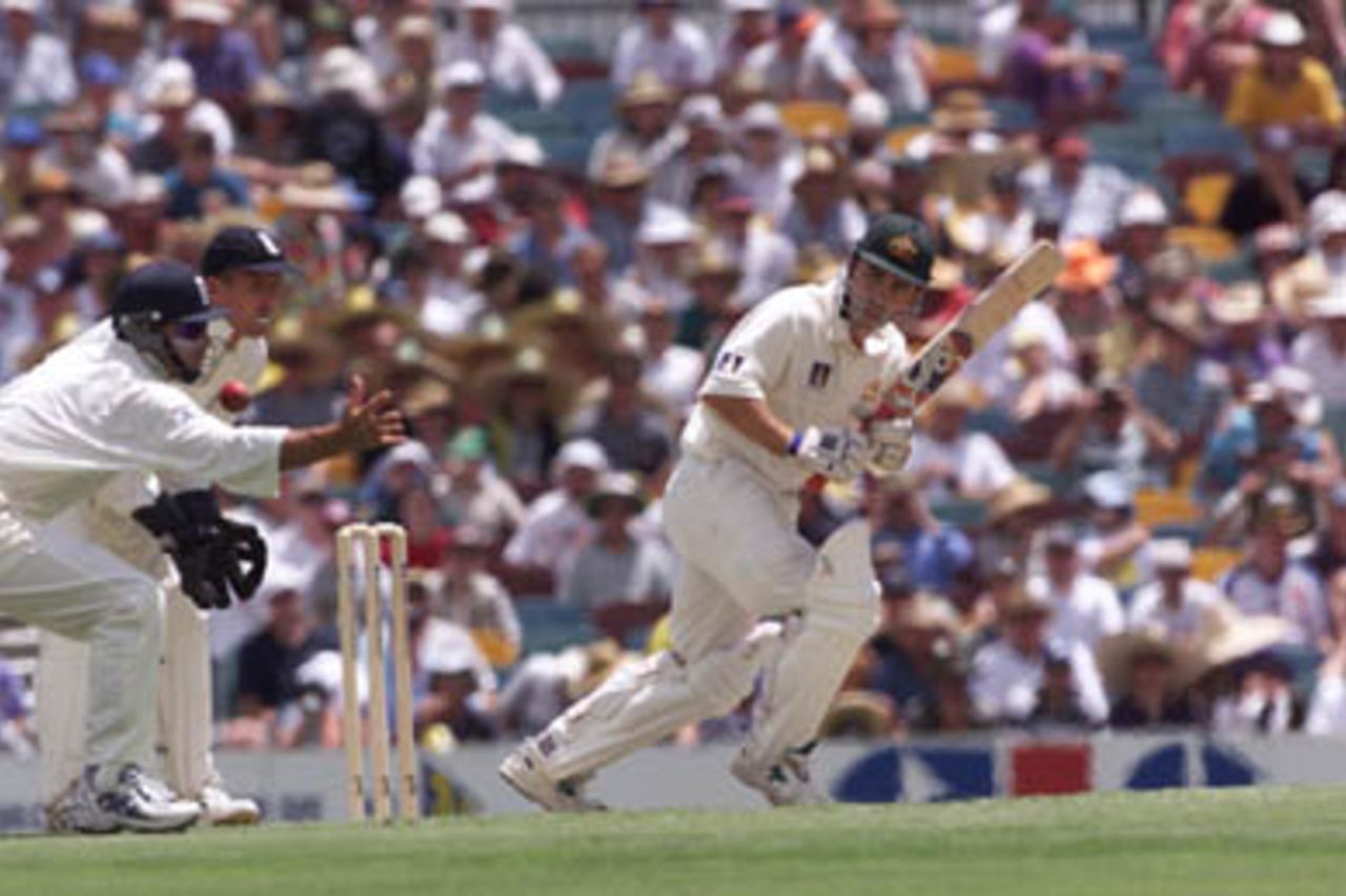 Mark Butcher in the slips just misses a ball edged by Justin Langer