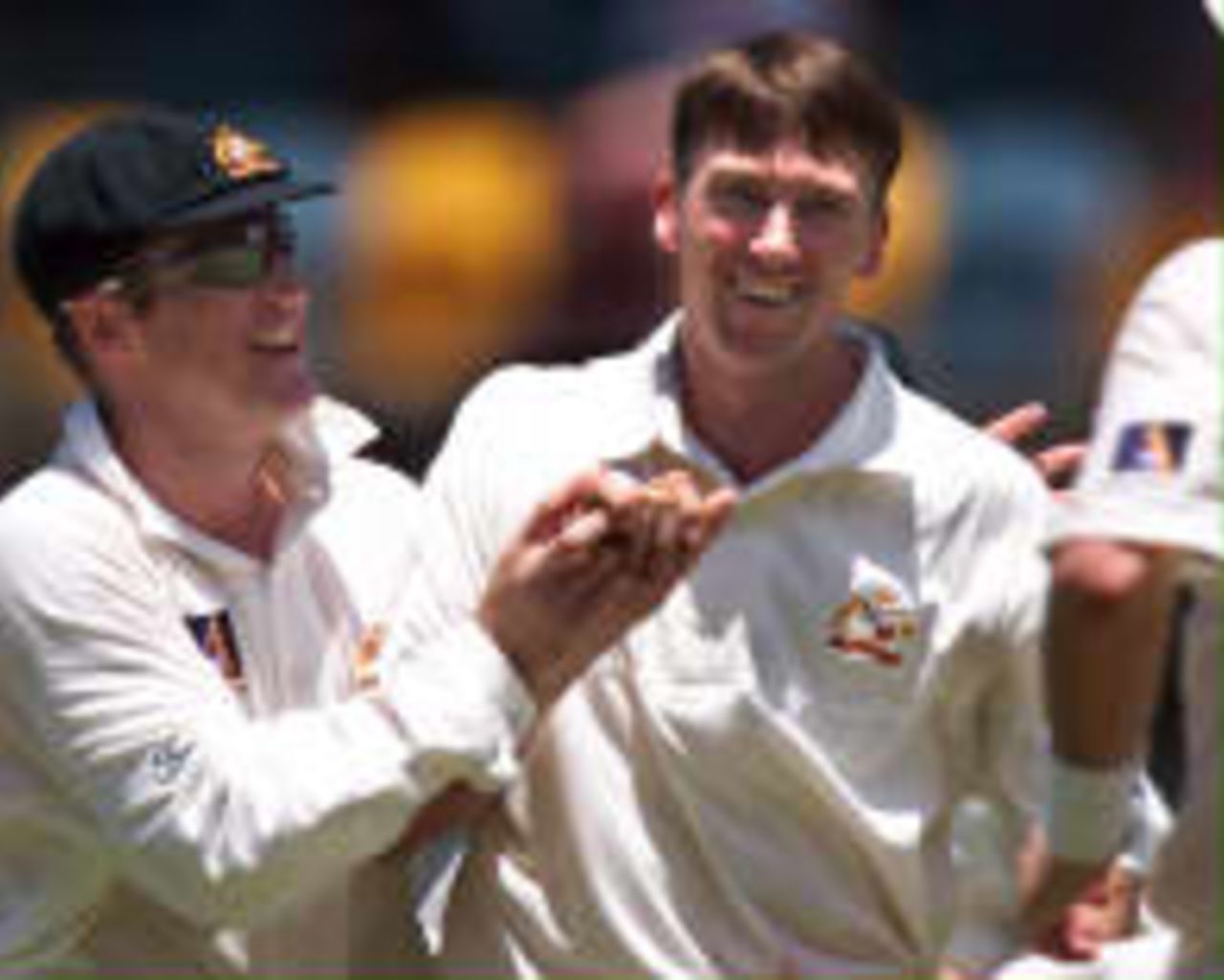 Australian fast bowler Glenn McGrath (R) is congratulated by his captain Mark Taylor (L) after McGrath captured six English wickets on the fouth day of the first Ashes Test being played at the Gabba in Brisbane 23 November. England lost 6-76 to be all out for 375 giving Australia a lead of 110 runs at lunch.