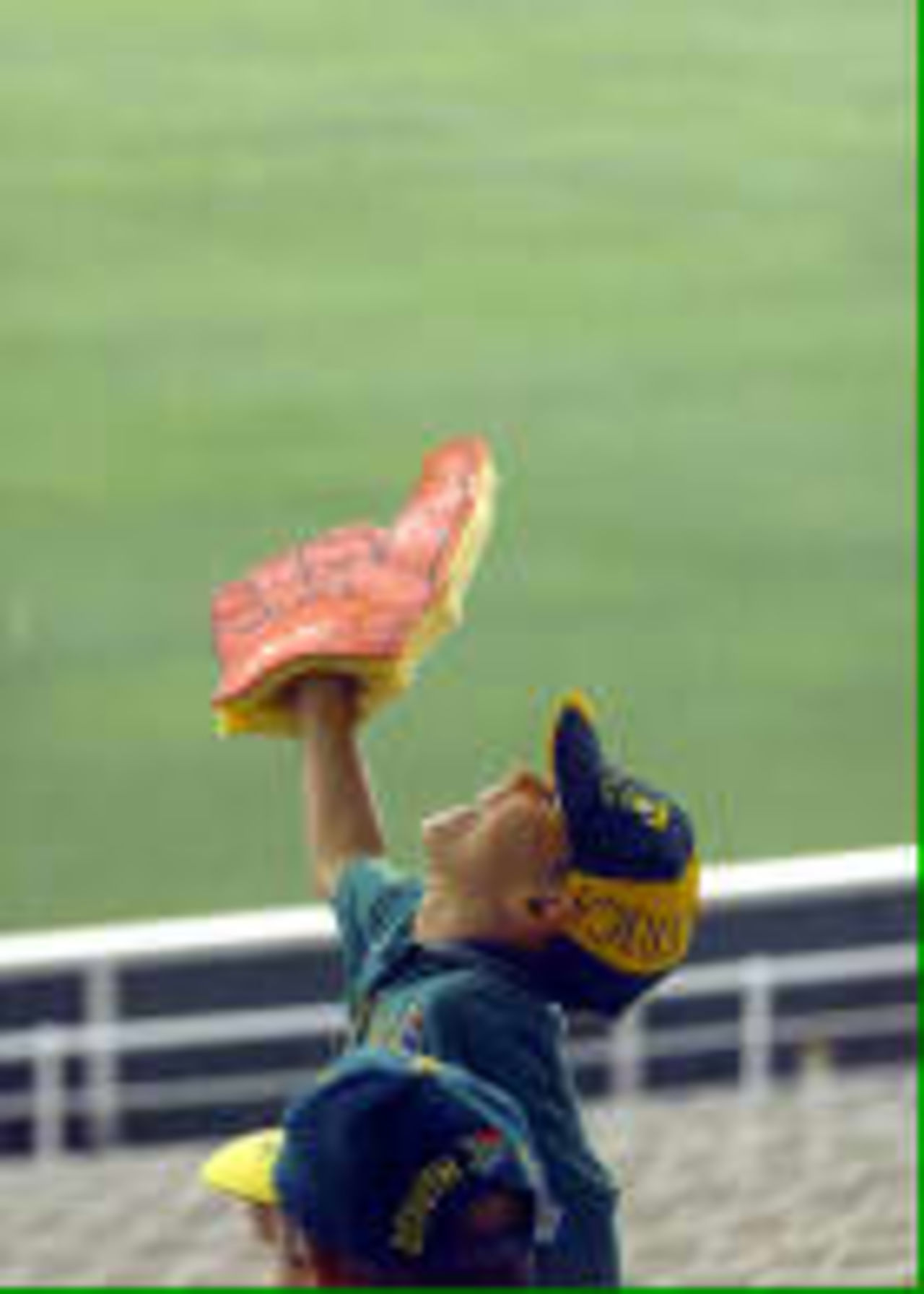 A young spectator trying to catch raindrops after rain stops play West Indies in South Africa, 1998/99, 1st Test South Africa v West Indies The Wanderers, Johannesburg 28 November 1998