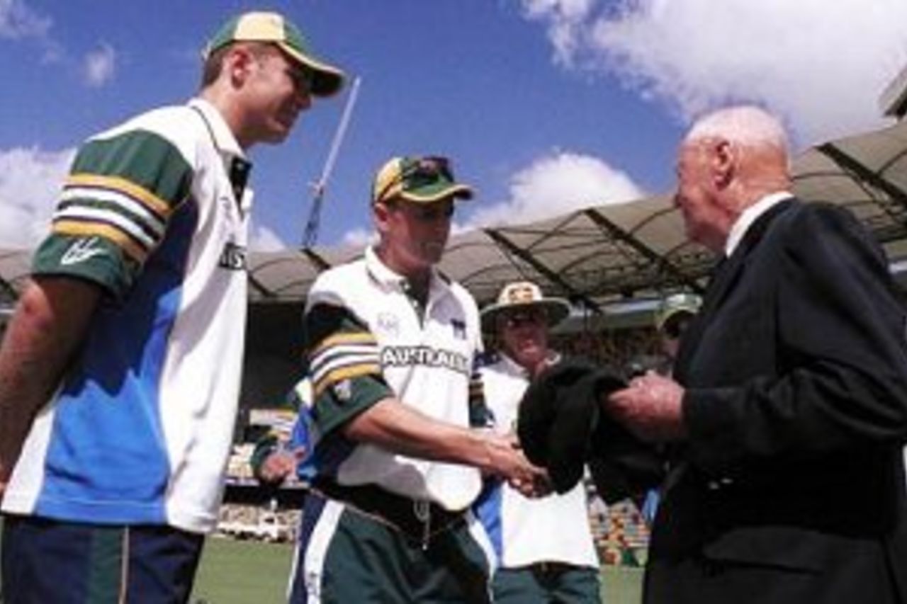 05 Nov 1999: Australian cricketing legend Bill Brown presents the cherished baggy green cap to Test debutants Scott Muller and Adam Gilchrist.