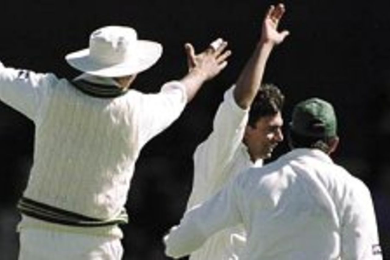19 Nov 1999: Pakistan players rush towards spin bowler Saqlain Mushtaq (centre) after Mushtaq has taken the wicket of Shane Warne for nought during day two of the Second test between Australia and Pakistan at Bellerive Oval, Hobart, Australia. Mushtaq finished with six wickets for forty six runs.