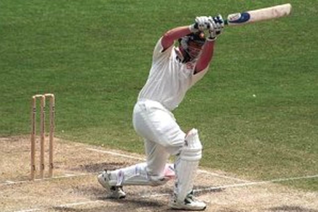 7 Nov 1999: Adam Gilchrist of Australia drives through mid off during his half century against Pakistan during the third days play of the First Test match between Australia and Pakistan at The Gabba, Brisbane, Australia.