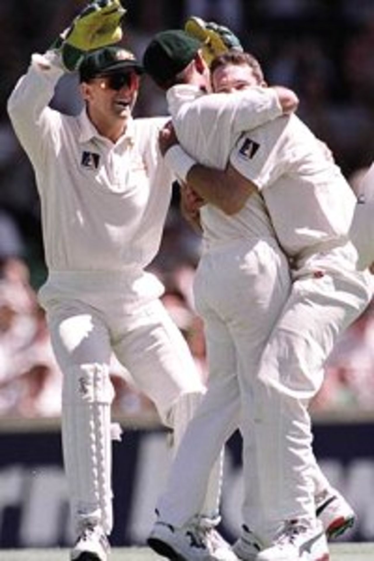 26 Nov 1999: Australian fast bowler Damien Fleming is congratulated by team mates after taking a diving catch off his own bowling to dismiss Pakistan batsman Moin Khan, during day one of the third test played between Australia and Pakistan at the WACA ground in Perth, Western Australia, Australia.