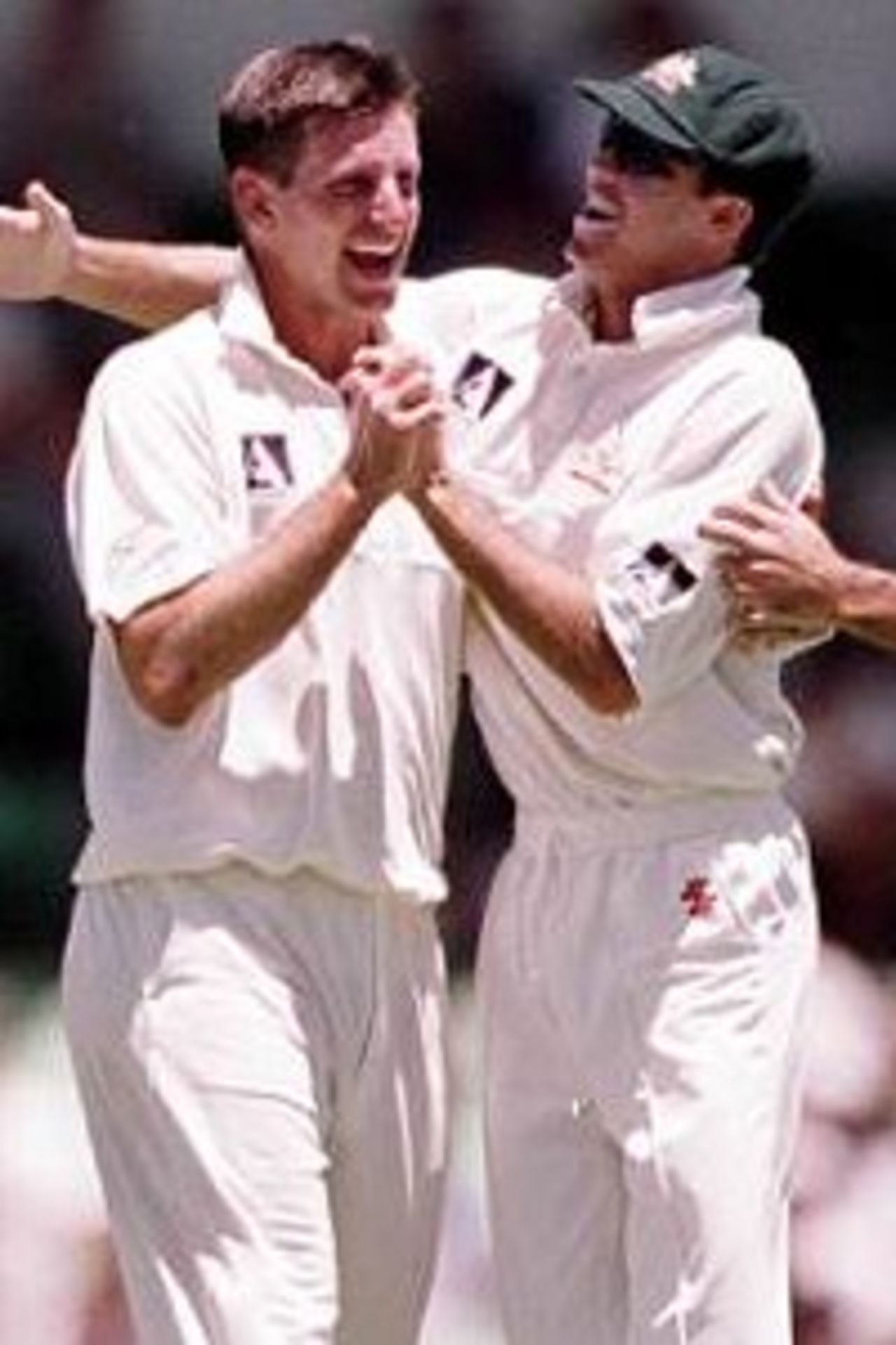 26 Nov 1999: Australian fast bowler Michael Kasprowicz is congratulated by team mate Greg Blewett after taking the wicket of Pakistan batsman Inzimam Ul Haq, during day one of the third test played between Australia and Pakistan at the WACA ground in Perth, Western Australia, Australia.