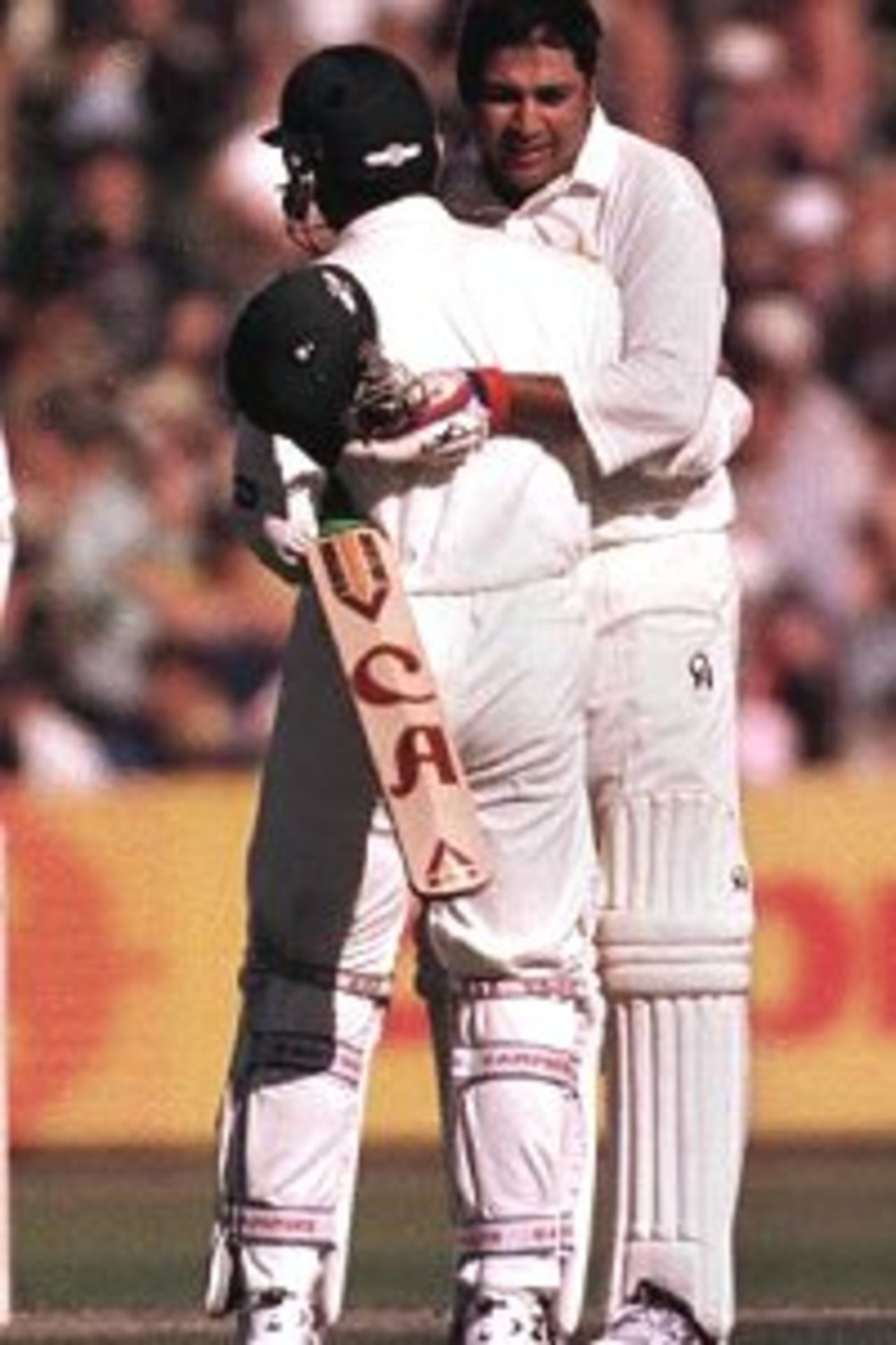 20 Nov 1999: Pakistan batsman Inzamam-ul-Haq is congratulated by team mate Moin Khan following his century during day three of the Second test between Australia and Pakistan at Bellerive Oval, Hobart, Australia. Inzamam-ul-Haq finished not out on 116 runs. Pakistan finished the day 327 runs ahead of Australia with three wickets in hand.