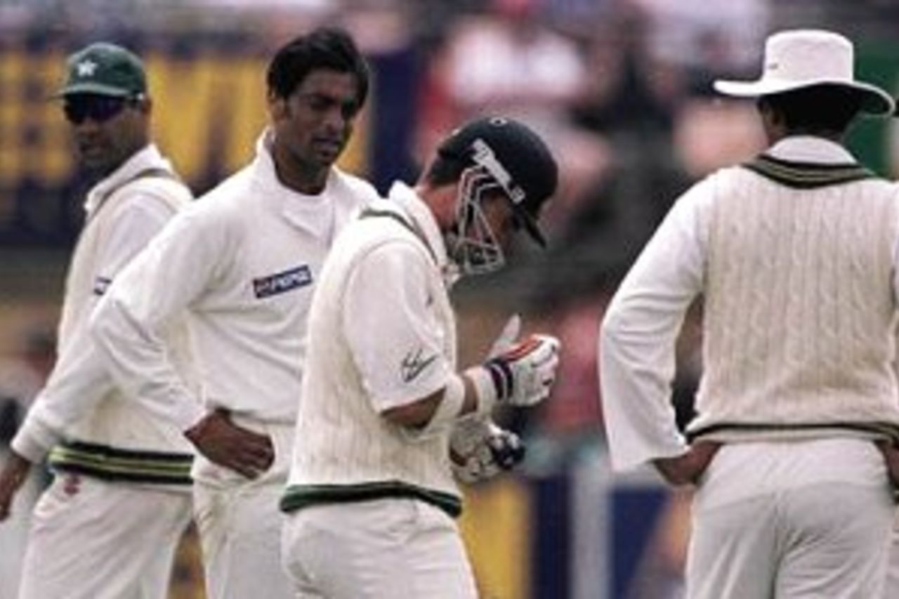 21 Nov 1999: Pakistan fast bowler Shoaib Akhtar looks at Australian batsman Justin Langer who is in pain after being struck in the hand by a Shoaib Akhtar delivery, the ball that struck Langer was clocked at one hundred and fifty four kilometers an hour,during day four of the Second Test between Australia and Pakistan at Bellerive Oval, Hobart, Australia.