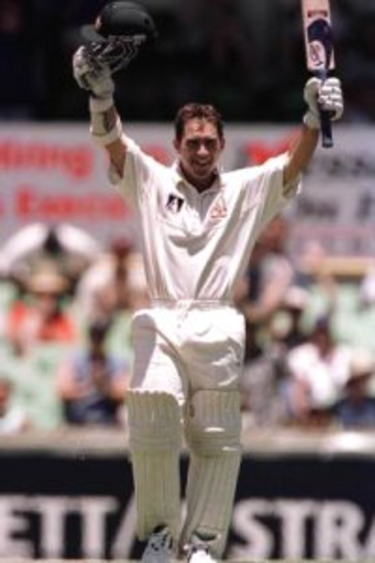 27 Nov 1999: Australian batsman Justin Langer is jubilant after scoring a century, during day one of the third test played between Australia and Pakistan at the WACA ground in Perth, Western Australia, Australia.