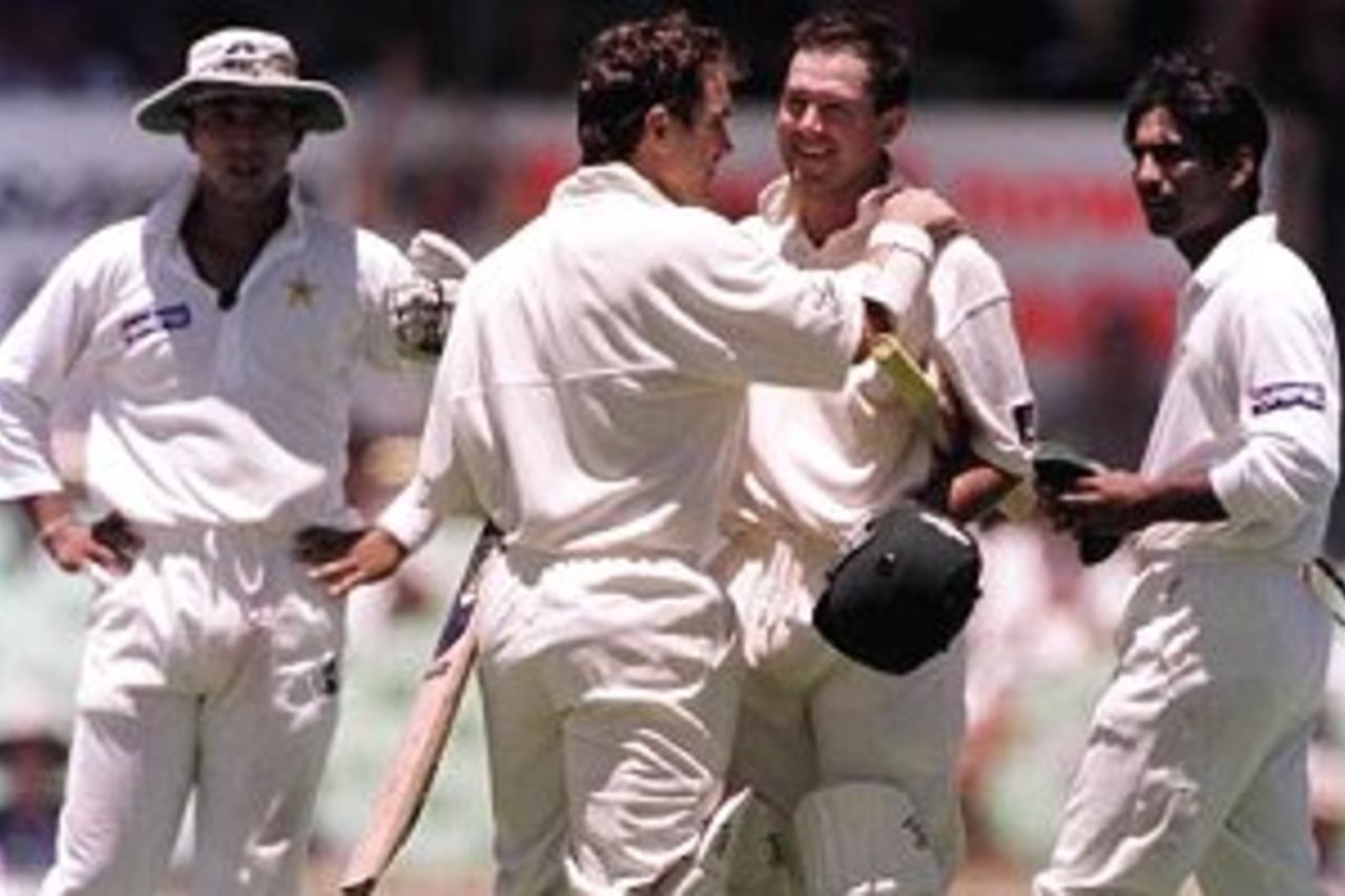 27 Nov 1999: Australian batsman Justin Langer congratulates Ricky Ponting upon scoring his century in the the first session of play, Pakistan fieldsmen Saeed Anwar and Yousaf Youhana look on, during day one of the third test played between Australia and Pakistan at the WACA ground in Perth, Western Australia, Australia.