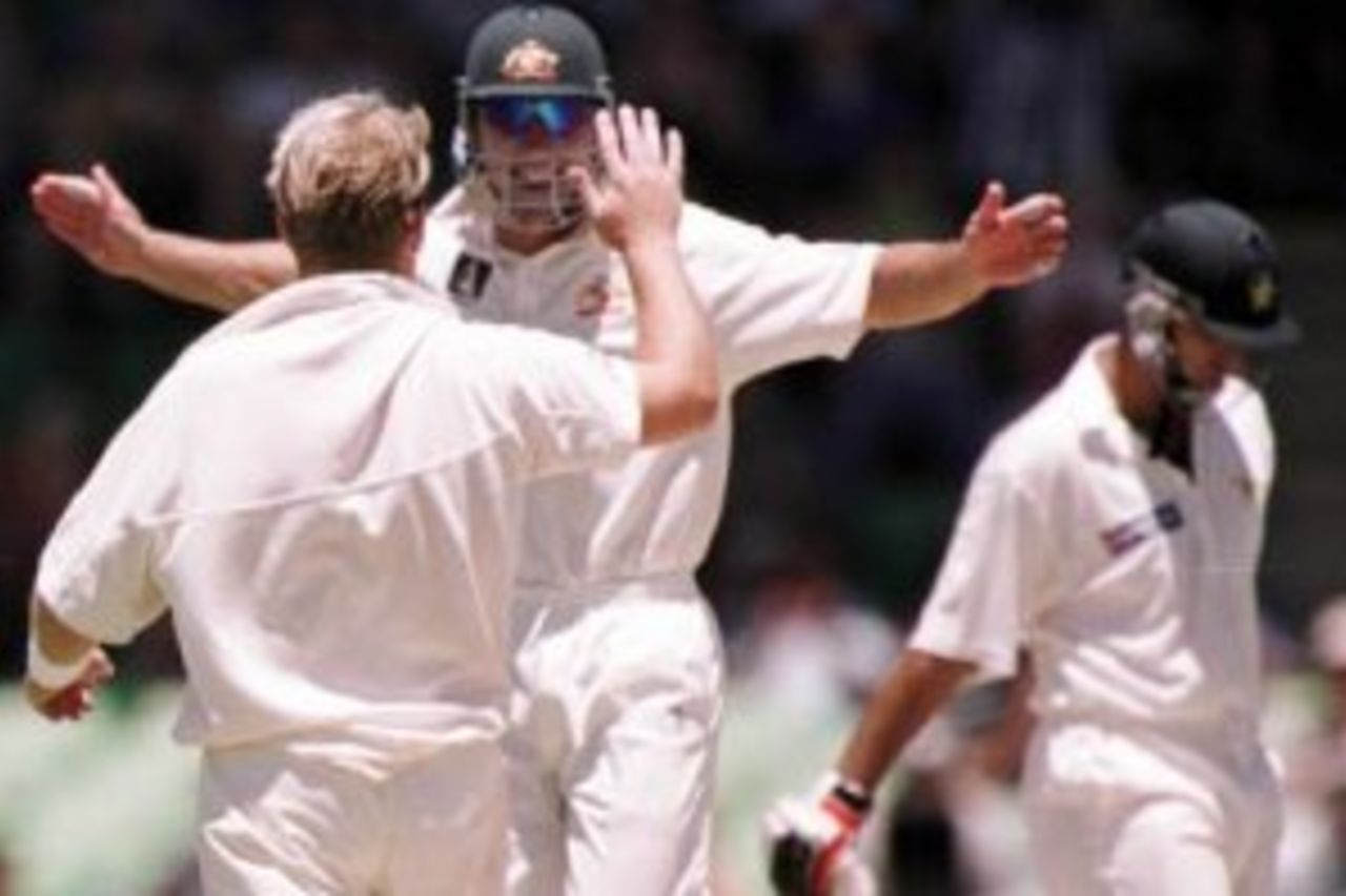 28 Nov 1999: Australian fieldsmen Justin Langer jumps for joy towards spin bowler Shane Warne who bowled Pakistan batsman Azhar Mahmood, during day three of the third test played between Australia and Pakistan at the WACA ground in Perth, Western Australia, Australia.