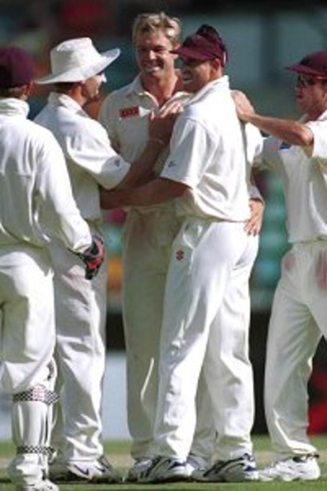 28 Nov 1999: Scott Muller of Queensland celebrates with team mates after taking a wicket against India at the Gabba Cricket Ground in Brisbane.