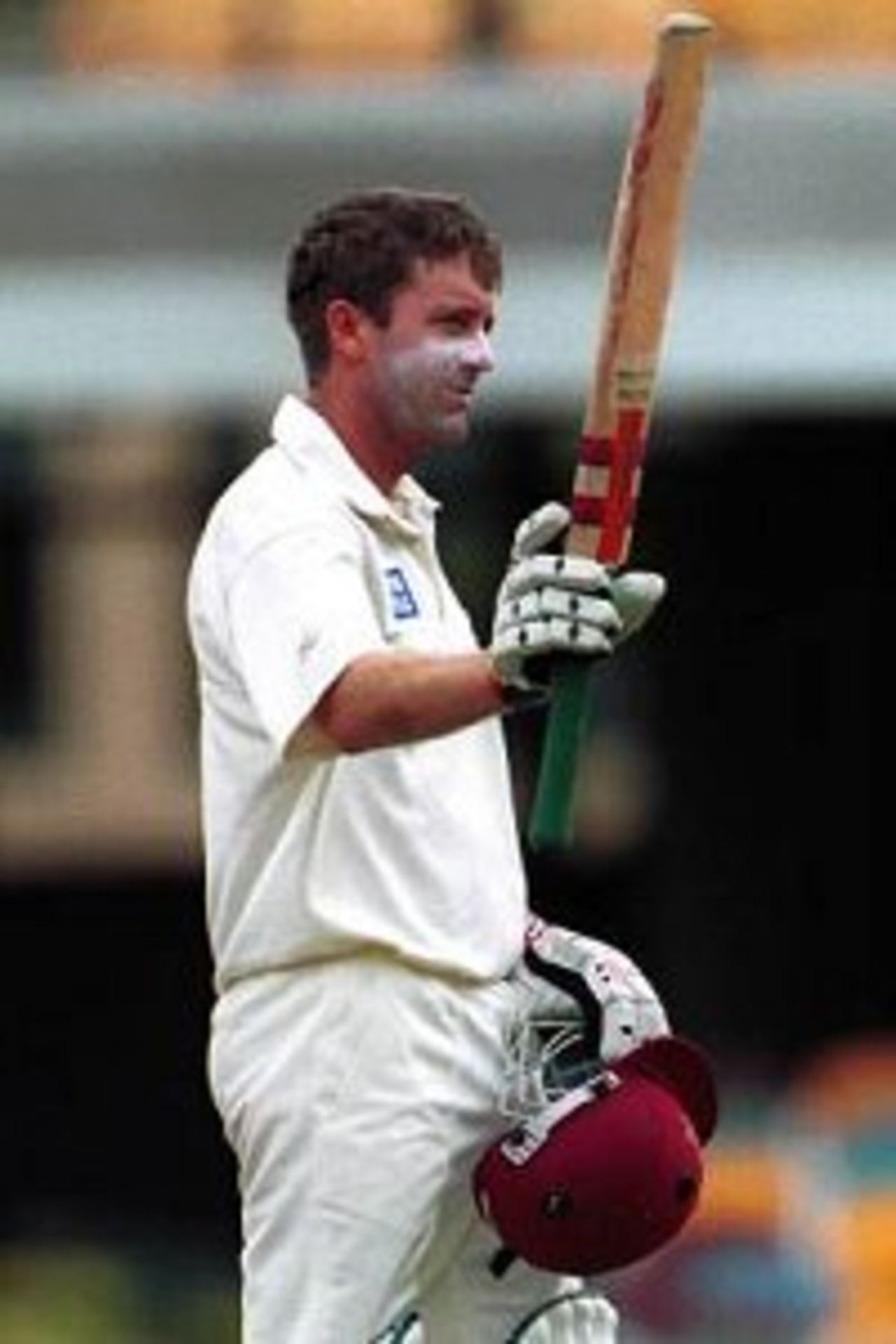 27 Nov 1999: Martin Love of Queensland celebrates scoring a century against India at the Gabba Cricket Ground in Brisbane, Australia.