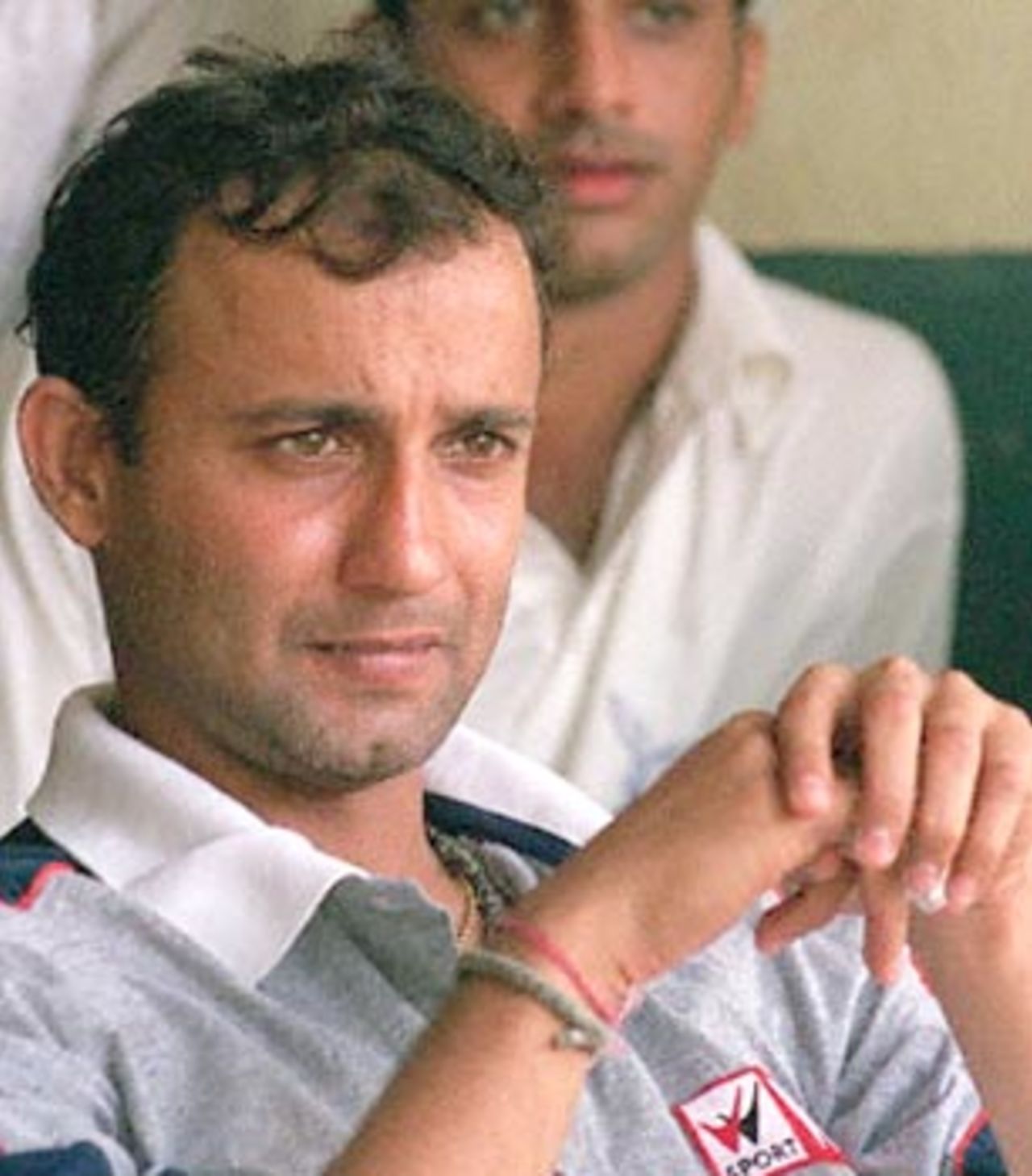 Former Indian wicketkeeper Nayan Mongia watches a local cricket match from the dressing room at a Bombay stadium 01 November 2000. A report on match fixing in cricket compiled by India's Central Bureau of Investigation (CBI) and made public 01 November, has alleged that Mongia was involved in rigging matches for cash.