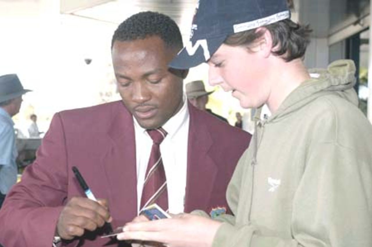 4 Nov 2000: Brian Lara of the West Indies cricket team signs an autograph for a fan upon his arrival this morning into Perth, as the West Indies begin preparations for their test series against Australia. Perth International Airport, Perth, Australia.