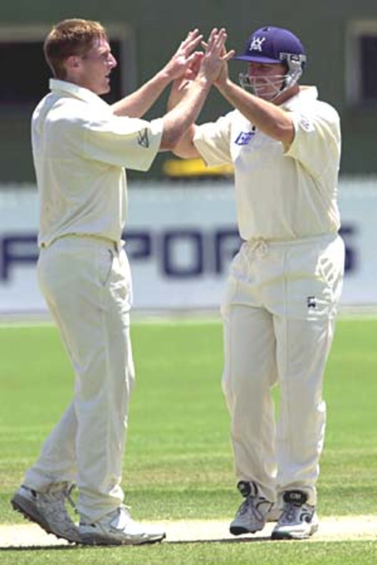 06 Nov 2000: Matthew Inness and Jason Arnberger of Victoria celebrate getting the wicket of Jimmy Maher of Queensland during the Pura Cup match between Queensland and Victoria played at Allan Border Field in Brisbane, Australia.