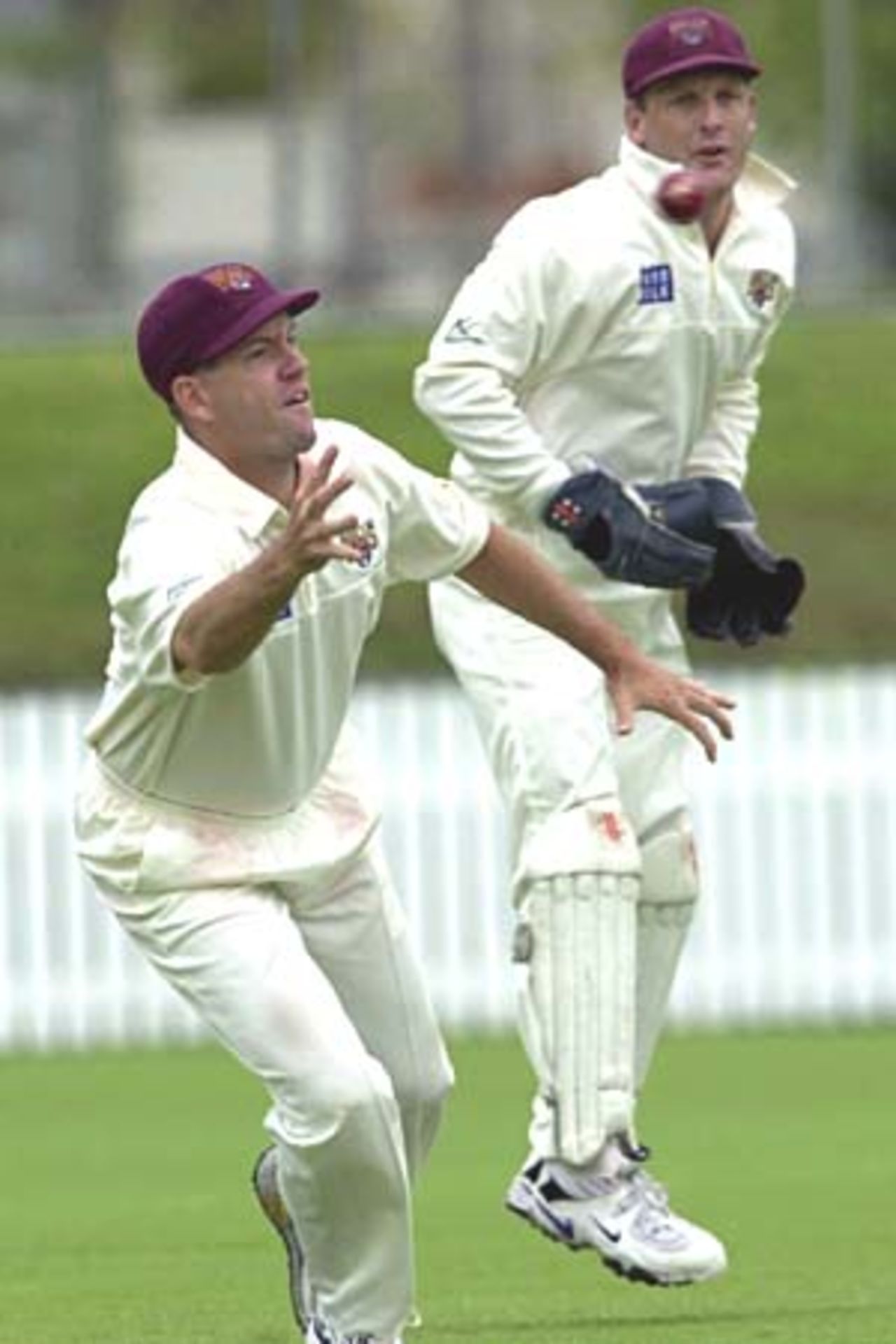 06 Nov 2000: Stuart Law of Queensland dives for a catch while Wade Seccombe looks on against Victoria during the Pura Cup match between Queensland and Victoria played at Allan Border Field in Brisbane, Australia.