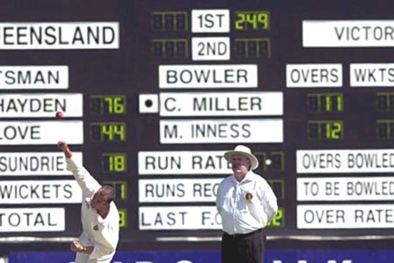06 Nov 2000: Colin Miller of Victoria bowls to Matthew Hayden of Queensland while umpire Jim Torpey looks on during the Pura Cup match between Queensland and Victoria played at Allan Border Field in Brisbane, Australia.