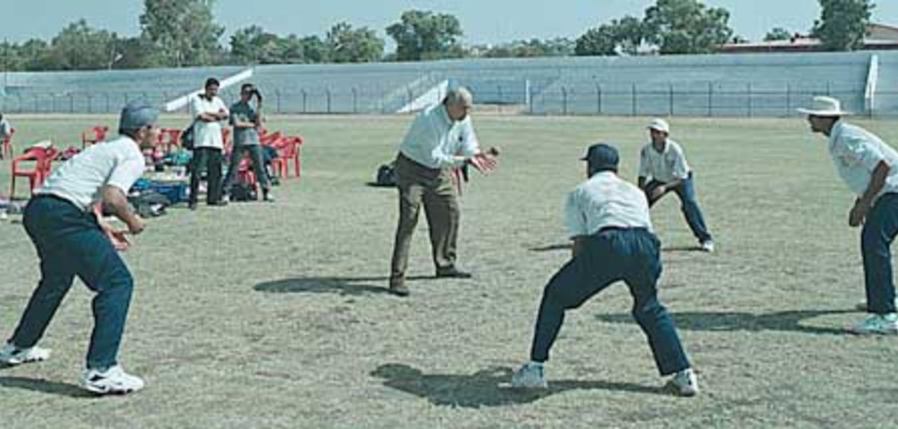 Raj Singh Dungarpur giving catch practice to Sodhi,Doru, Gambhir and Patel, (National Cricket Academy XI team), Zimbabwe in India, Nehru Stadium, 07 November 2000