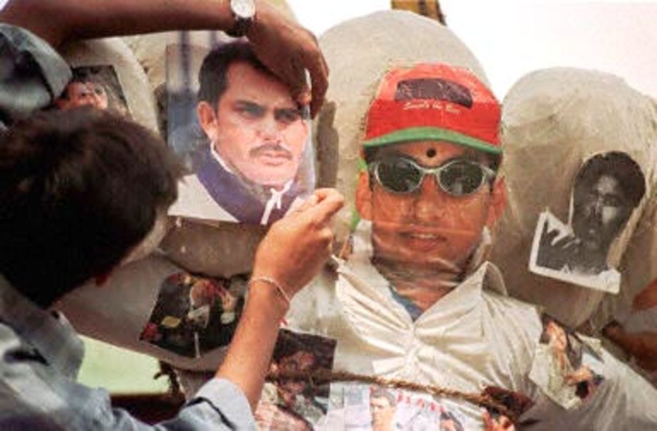 A member of the student's wing of the Bharatiya Janata Party (BJP) pins a picture of Indian cricket player Mohammad Azharuddin on an effigy, along with pictures of four other Indian players which was burnt during a demonstration in Bangalore 06 November 2000. Five Indian cricket players, Ajay Jadeja, Manoj Prabhakar, Ajay Sharma, Mohammad Azharuddin and Nayan Mongia have been banned from the game by India's cricket board after the Central Bureau of Investigation (CBI) named them along with other international cricket players in their match-fixing report.