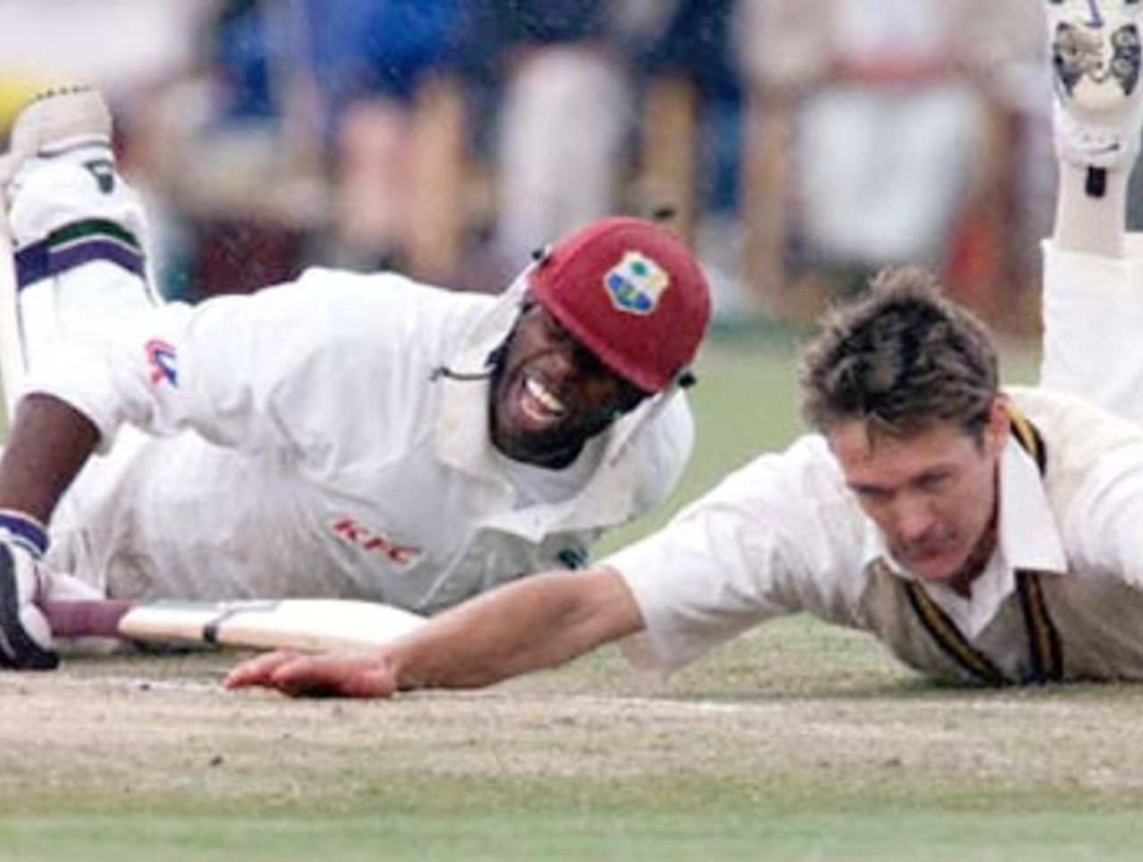 Sherwin Campbell of the West Indies (L) dives to make his ground, as bowler Stuart Karppinen attempts a run-out during an exhibition match at Lilac Hill near Perth, 07 November 2000. The match is being played between the West Indies test side and the Australian Cricket Board Chairman's X1 and is the touring sides first official fixture. Campbell, the vice-captain of the West Indies is currently on 61runs.