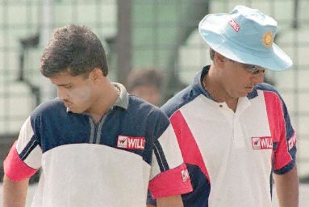 Indian cricket team skipper Sourav Ganguly (L) passes coach Anshuman Geakwad as they arrive for a practice session at Bangabandhu National Stadium, 08 November 2000, in Dhaka. India will play a maiden test against Bangladesh from 10 to 14 November 2000.