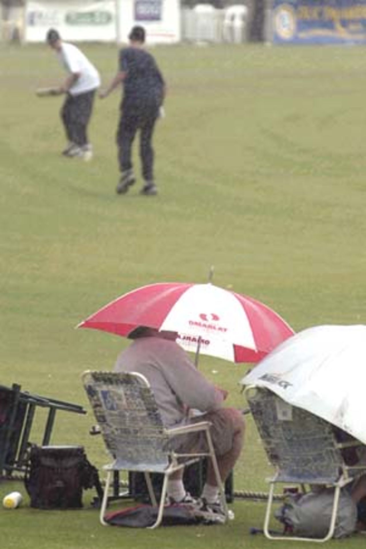 07 Nov 2000: Spectators play on as the match between the Australian Cricket Board's Chairman's XI and the West Indies is washed out at Lilac Hill in Perth, Australia.