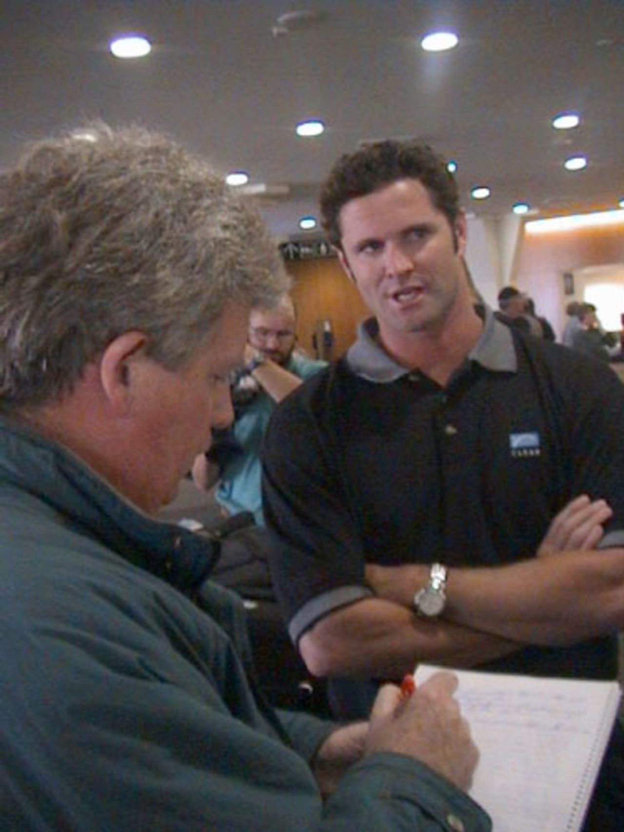 Injured New Zealand all-rounder Chris Cairns talks to CricInfo New Zealand Editor Lynn McConnell upon arriving at Christchurch International Airport from South Africa, 7 November 2000