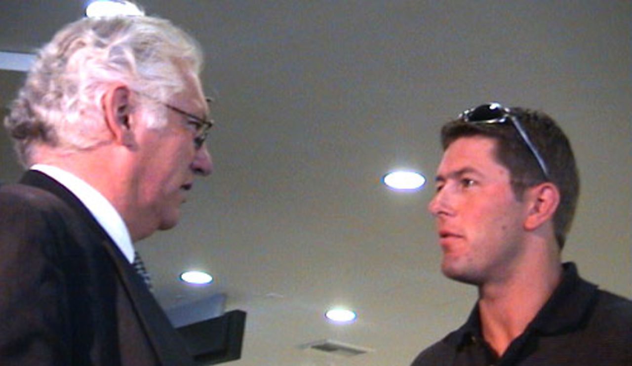 New Zealand bowler Geoff Allott talks to New Zealand chief executive Christopher Doig upon arriving at Christchurch International Airport from South Africa, 7 November 2000